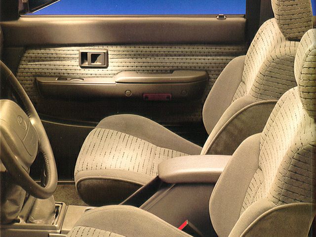 Fabric upholstery front seats with armrest and door panel interior details