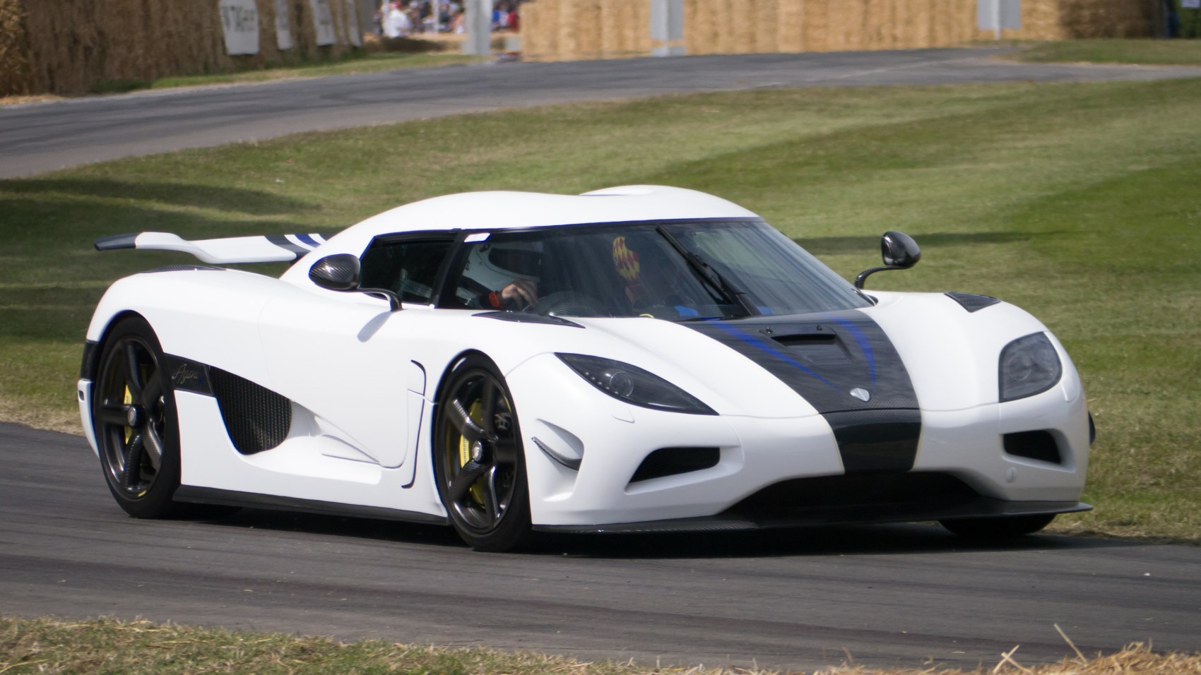 White sports car with carbon fiber accents and aerodynamic body