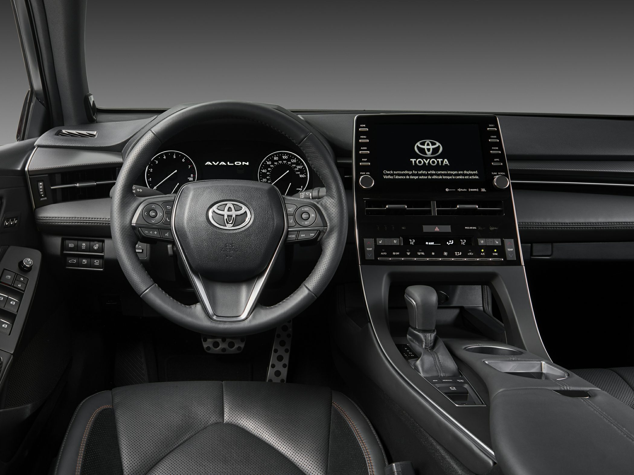Steering wheel and large touchscreen infotainment system in car interior