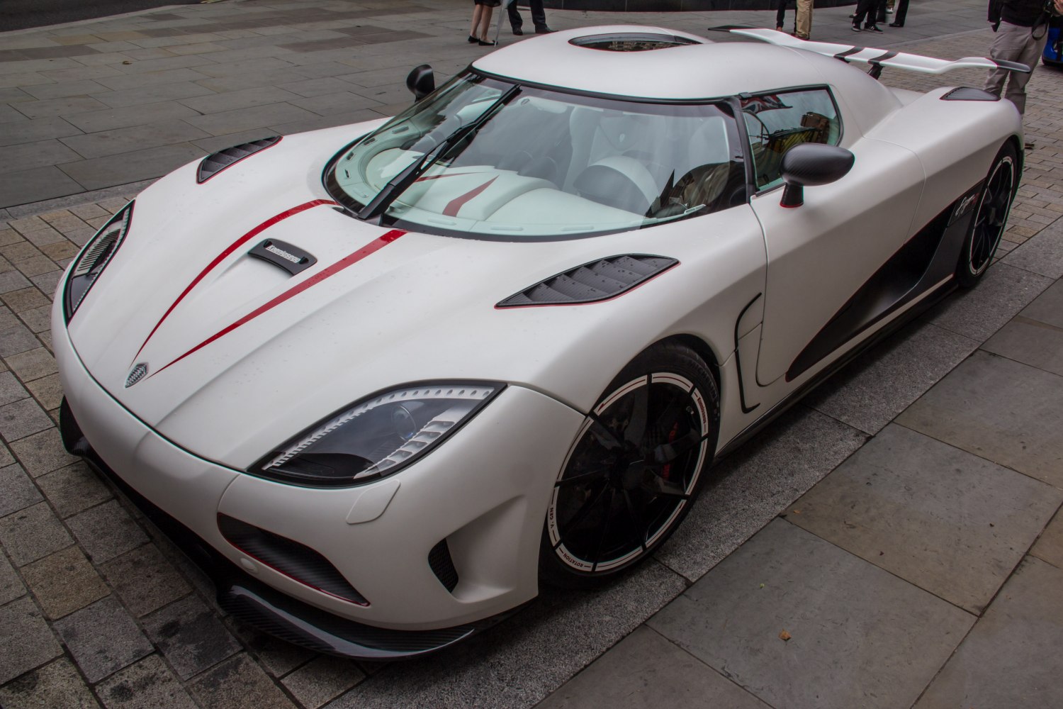 White sports car with aerodynamic design and red racing stripe
