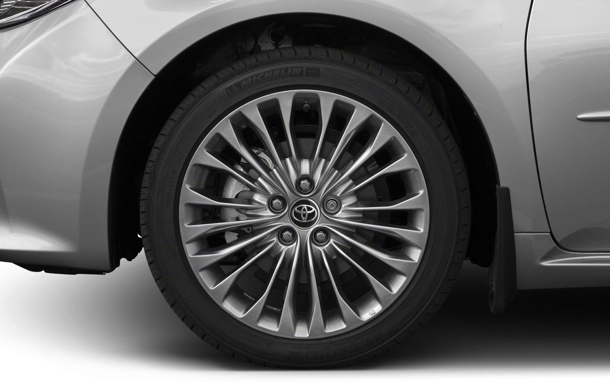 Multi-spoke alloy wheel with Michelin tire on silver-colored vehicle.