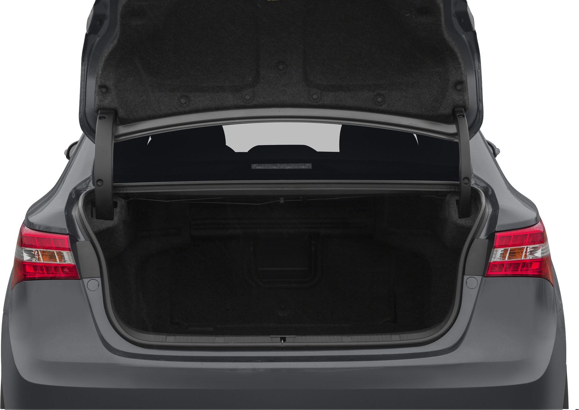 Large open trunk of a sedan with rear taillights visible