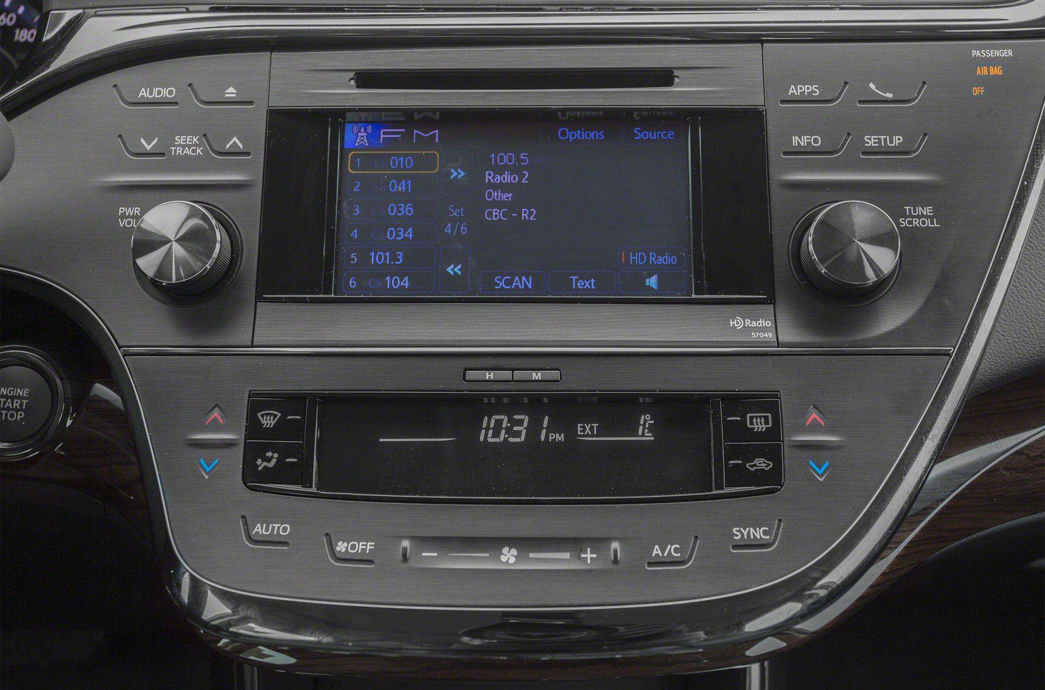 Car multimedia touchscreen, radio controls, and dual-zone climate control.