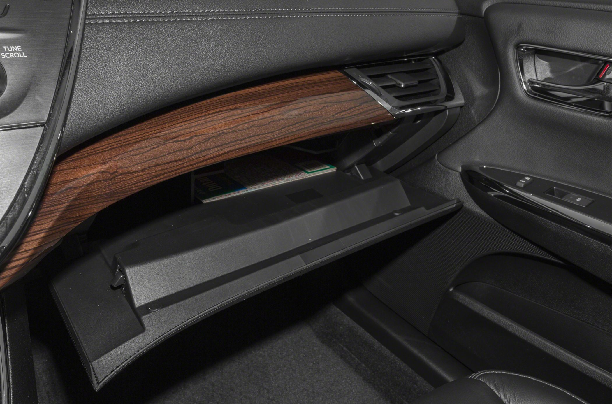 Open glove compartment and wood trim dashboard with air vent