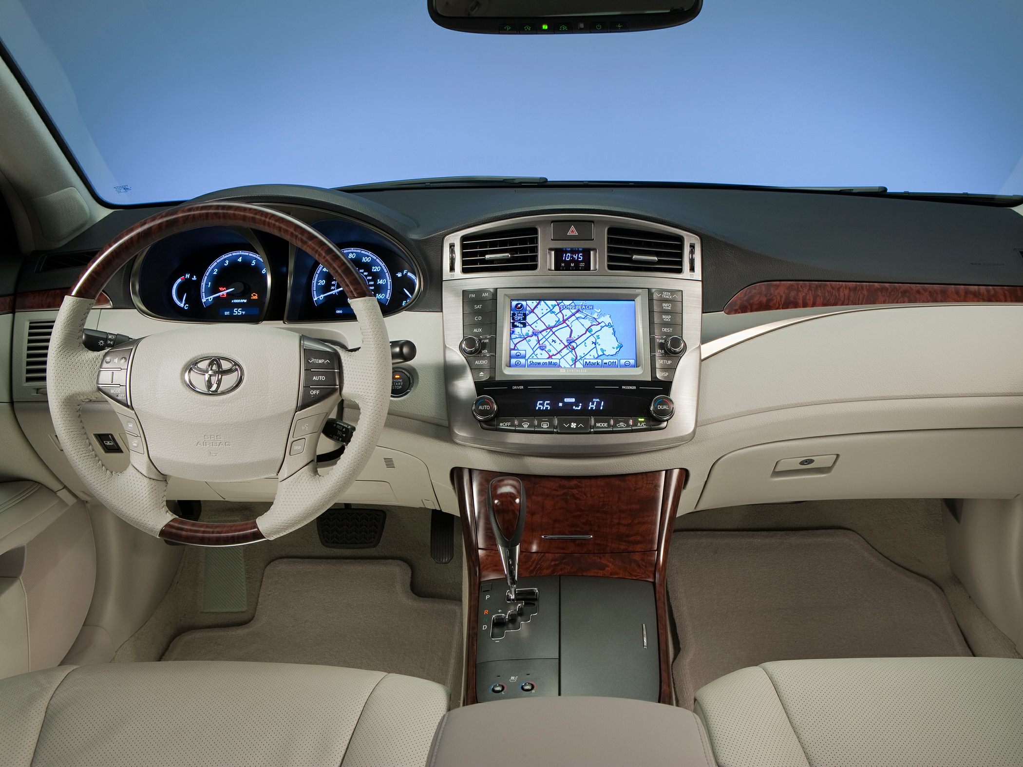 Car interior with GPS navigation, wood trim, and dual-zone climate controls