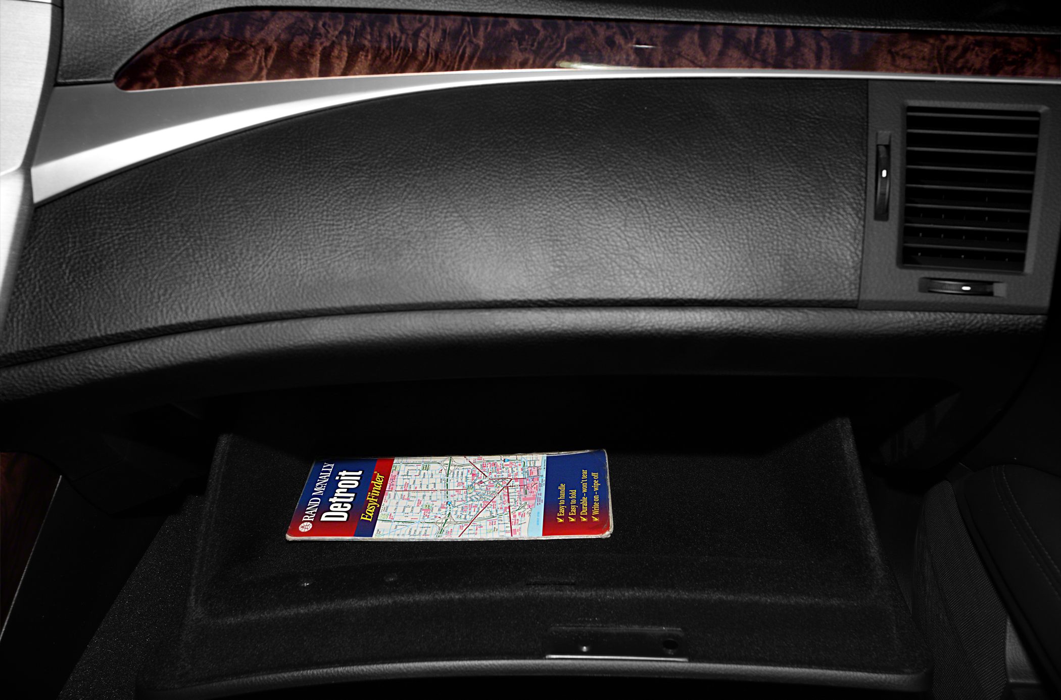 Glovebox interior with map, dashboard trim, air vent