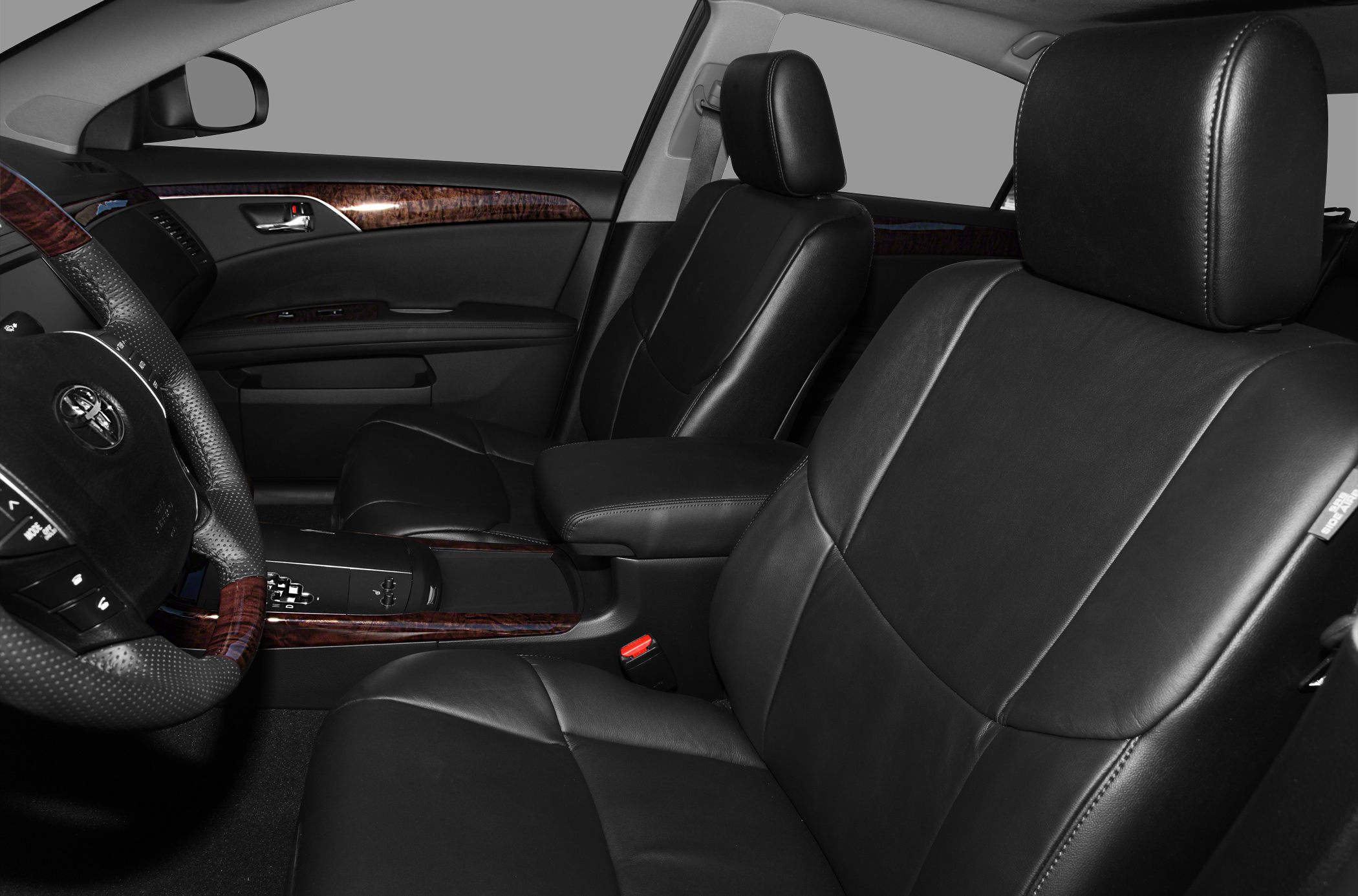 Black leather seats and wood trim accents in front cabin