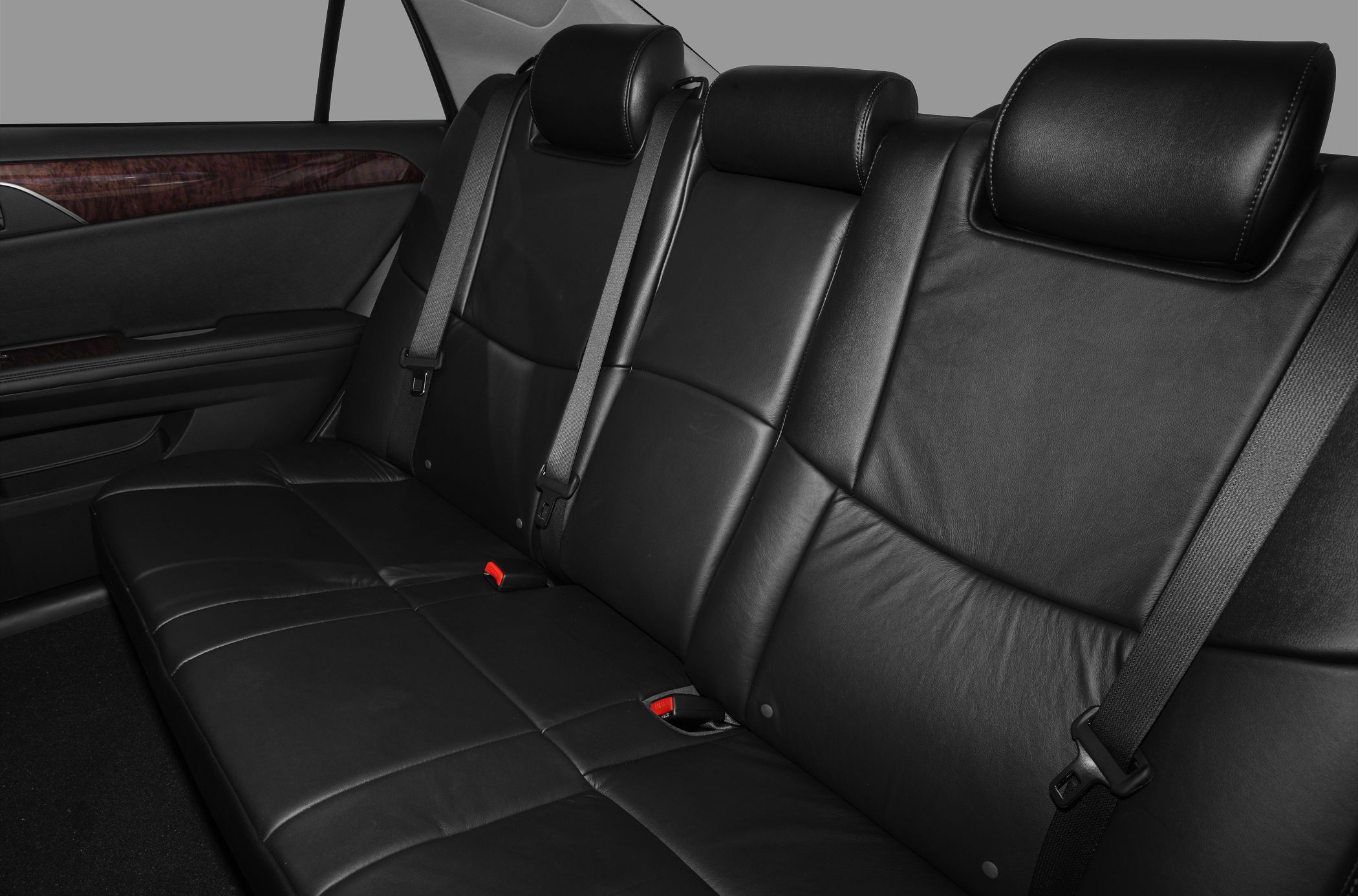 Premium black leather rear seat with seat belts and wooden door trim