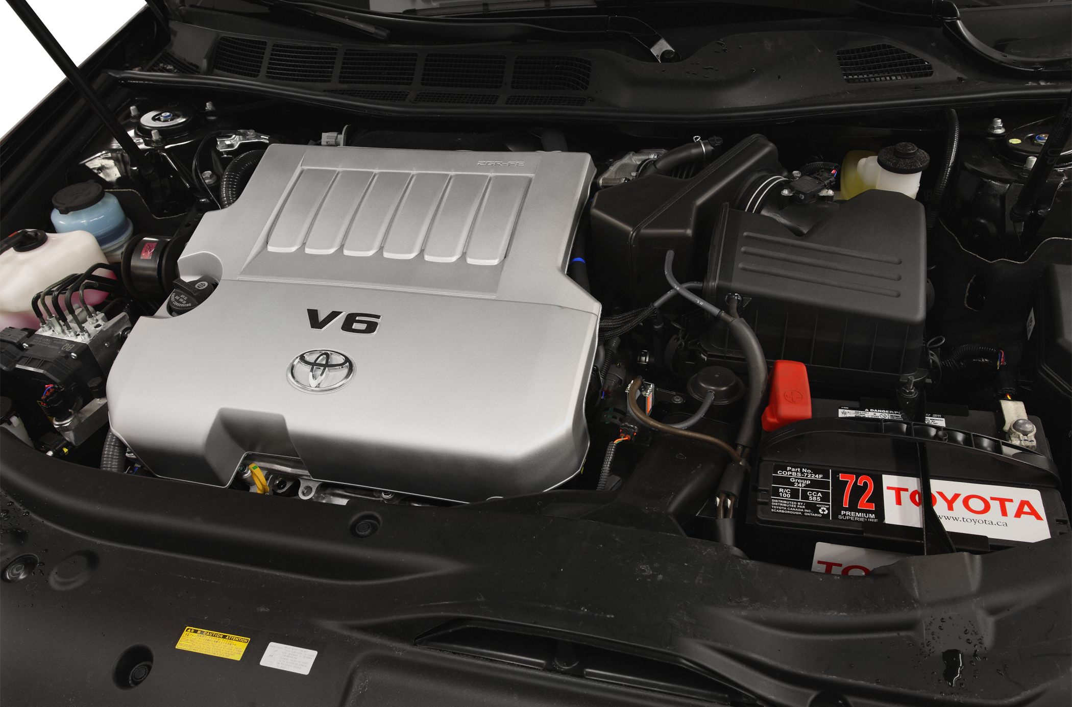 V6 engine with silver cover and Toyota battery in engine bay
