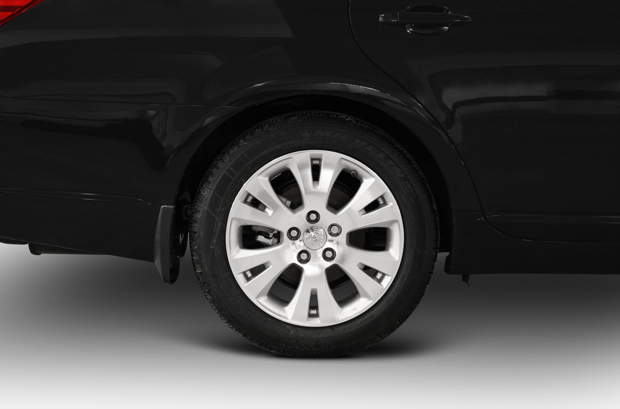 Rear alloy wheel and fender close-up with tire details