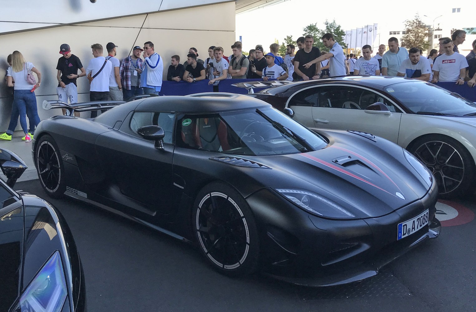 Matte black supercar with aerodynamic vents and prominent rear wing