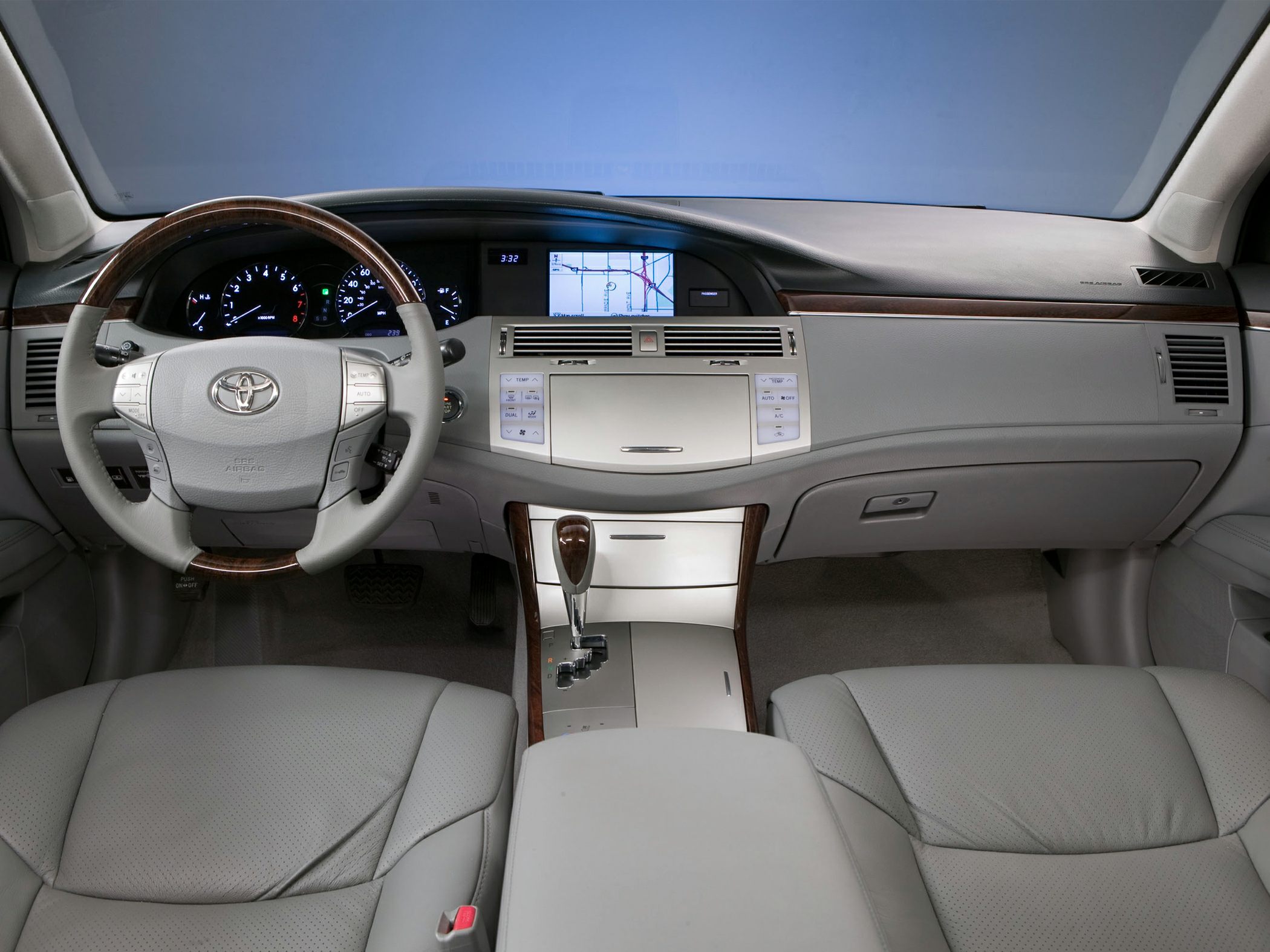 Interior dashboard with navigation screen and wood-trimmed steering wheel