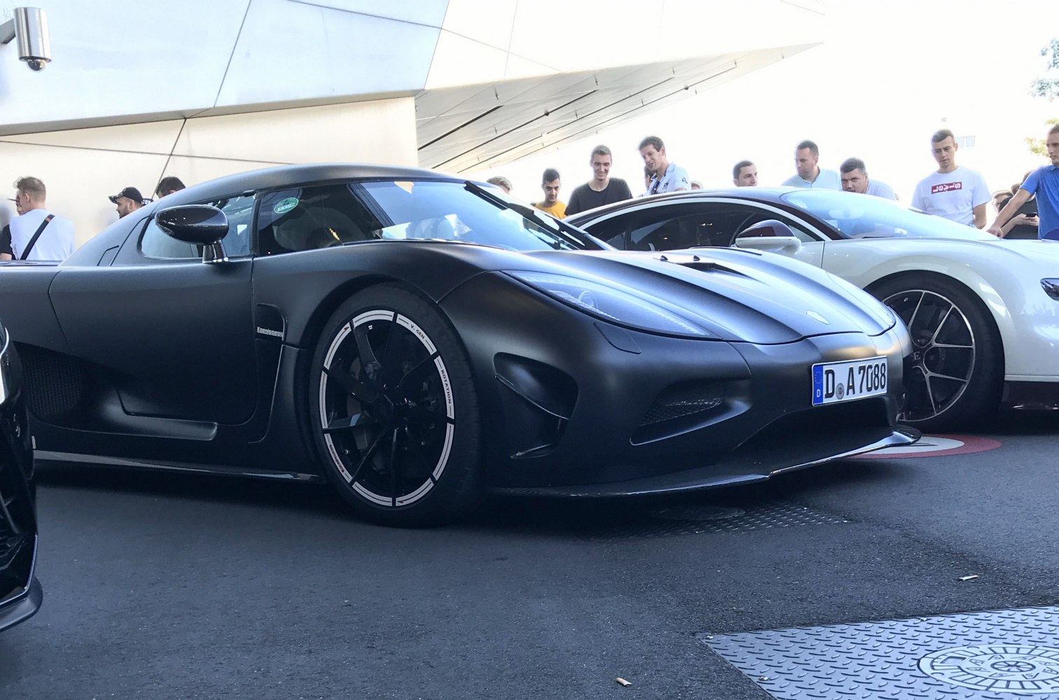 Matte black supercar front with aerodynamic design and sporty wheels