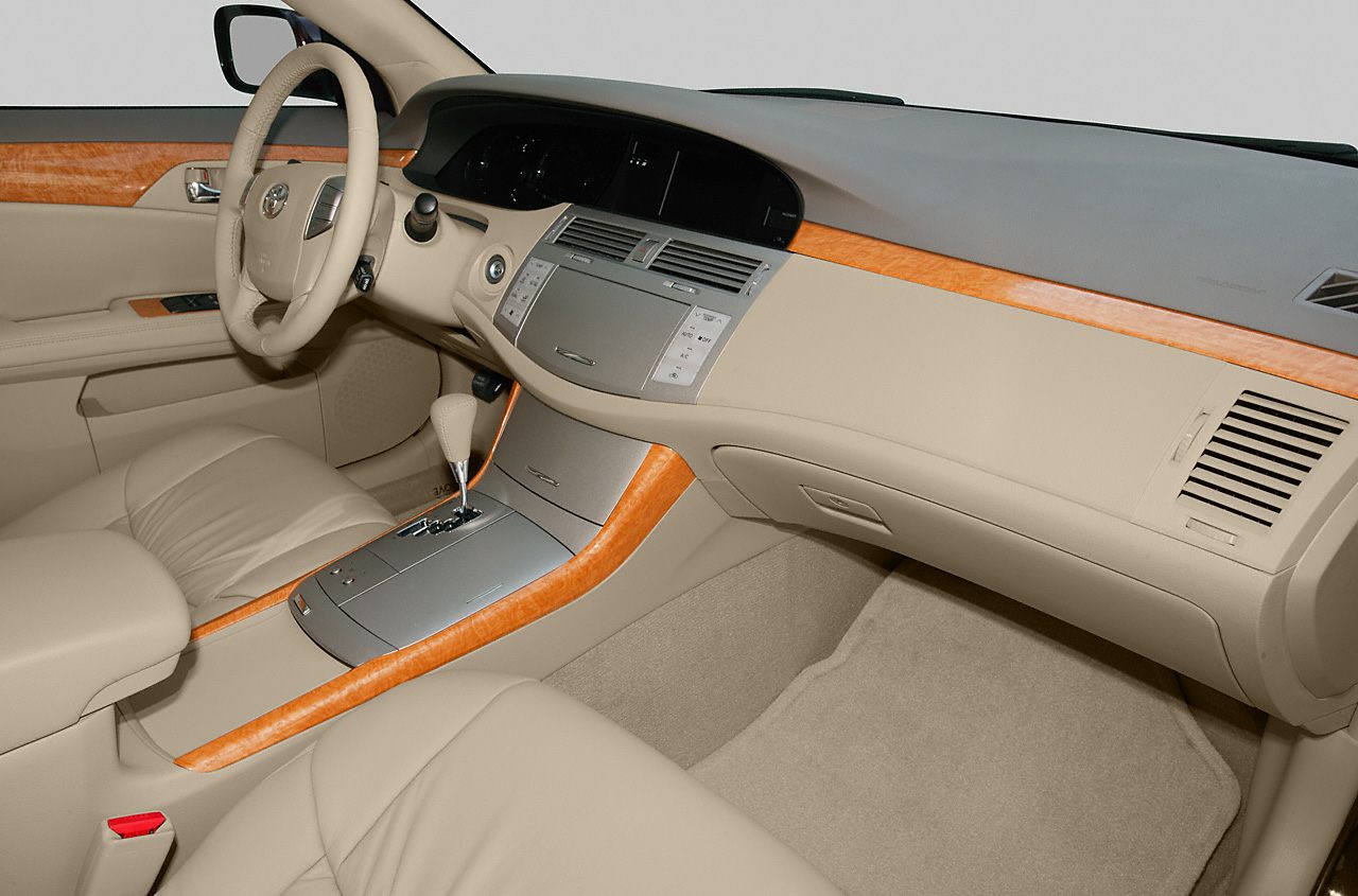 Beige leather interior with wood trim and advanced dashboard controls