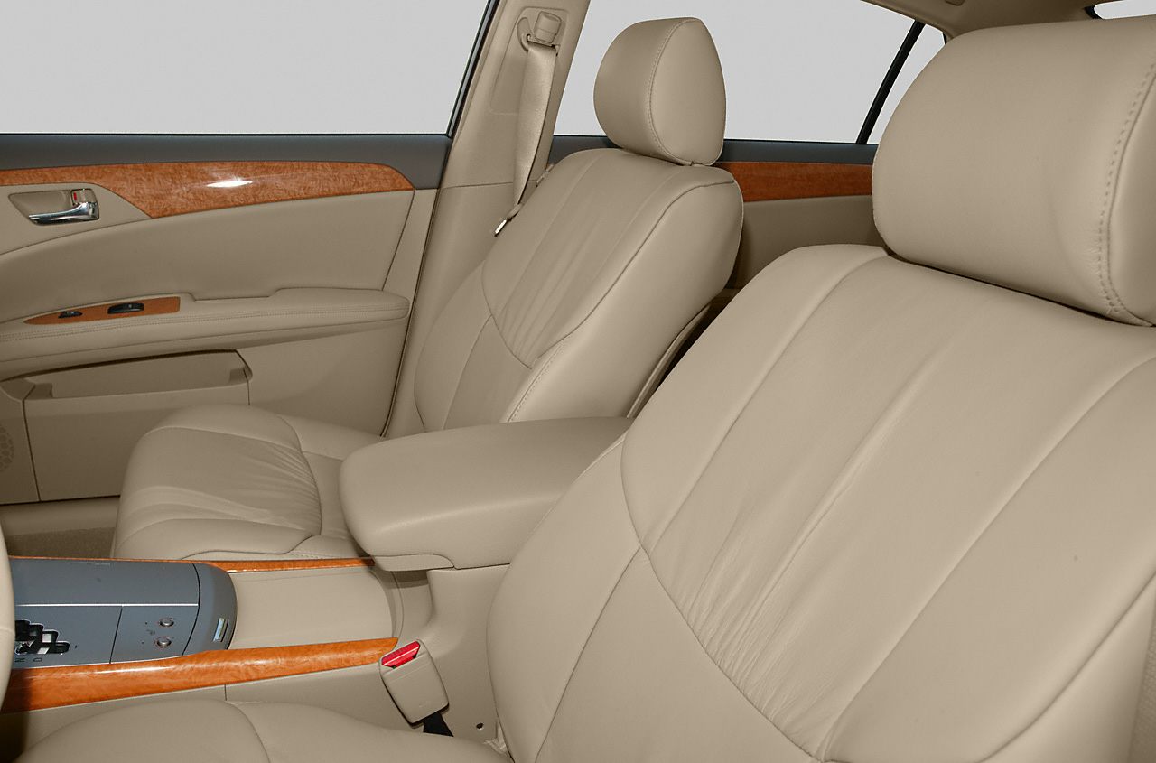 Beige leather front seats with wood trim accents and center console.