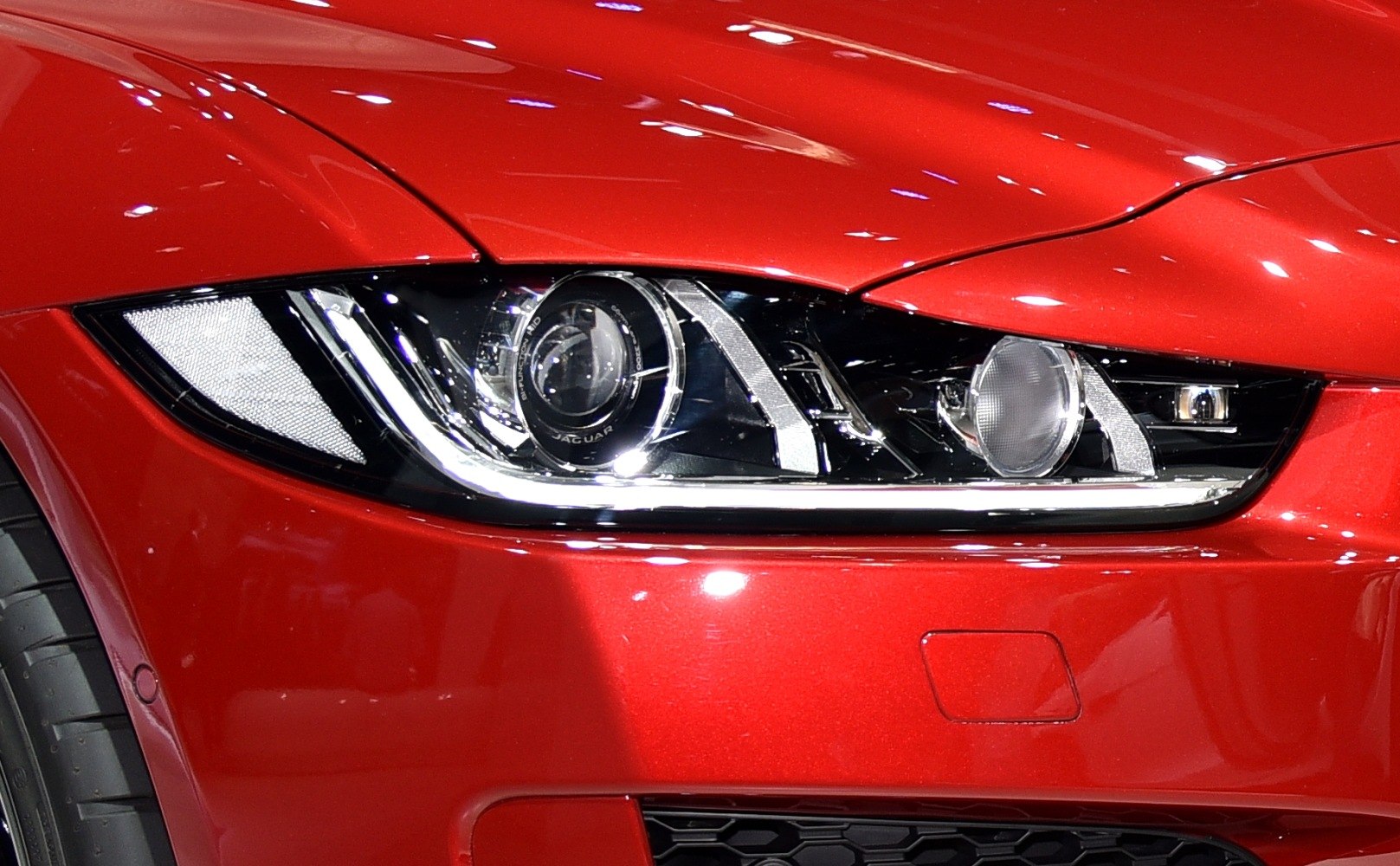 Close-up of sleek front headlight assembly with projector lamp and LED accent