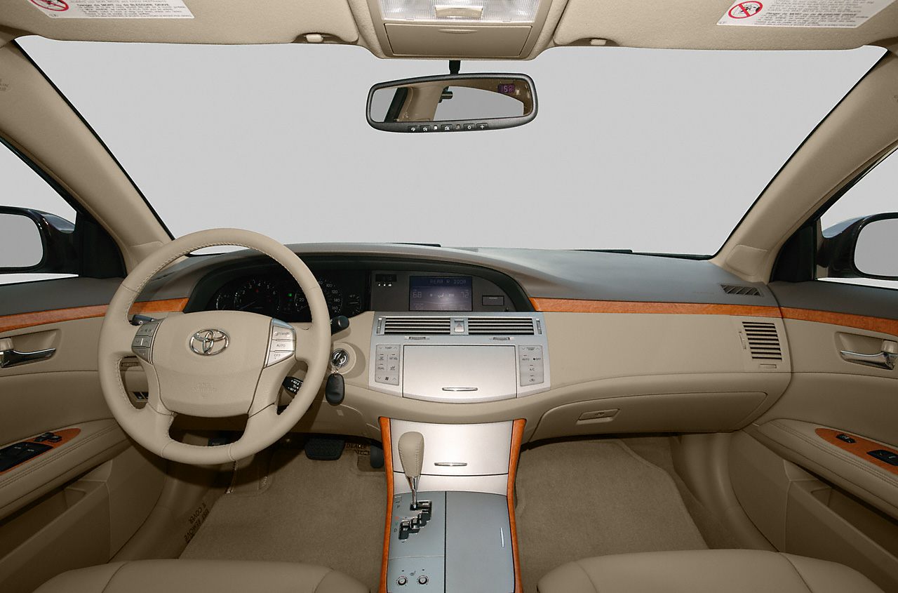 Beige dashboard and steering wheel with wood trim accents in car interior