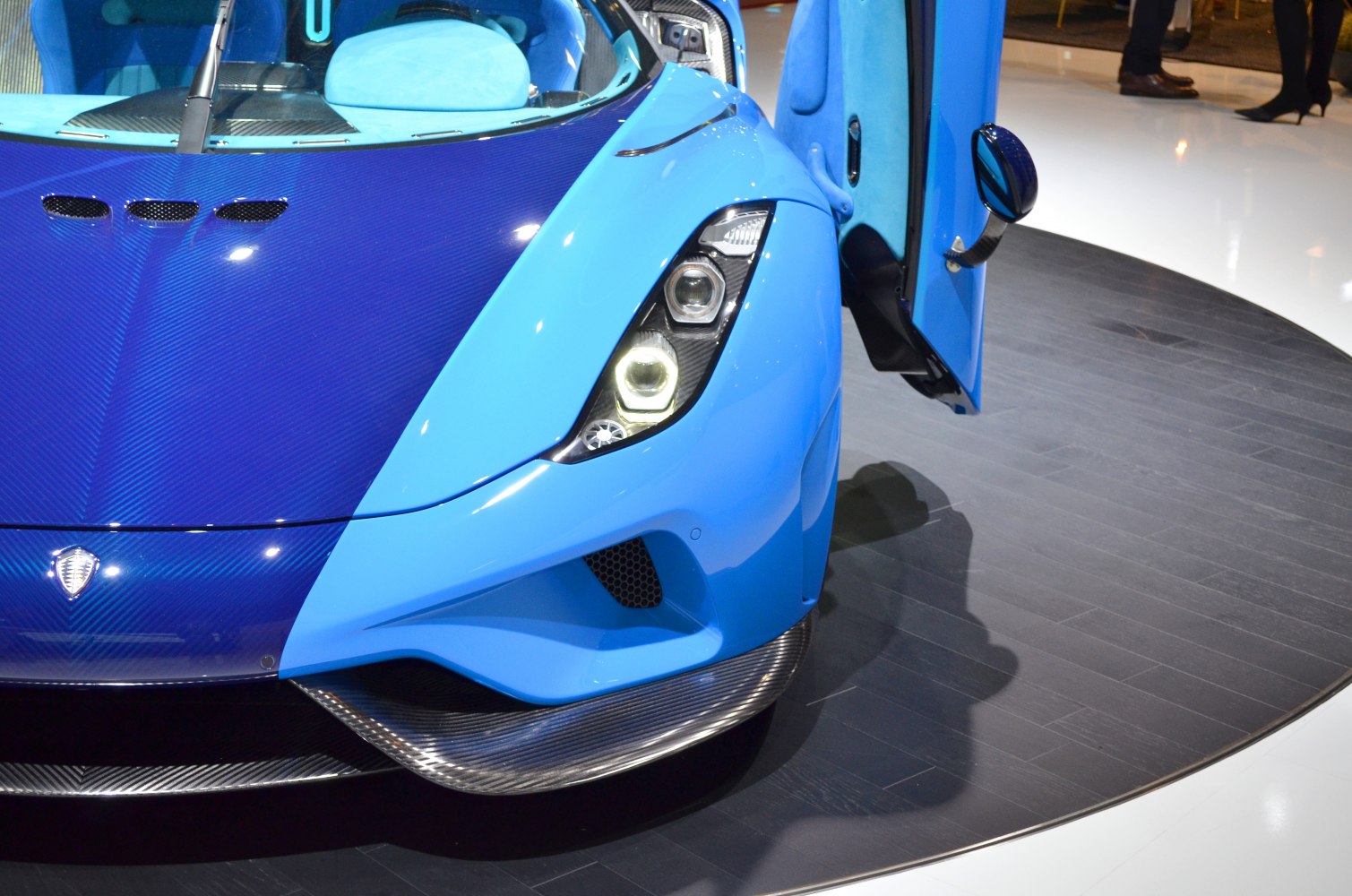Close-up of front headlight and carbon fiber hood with open door