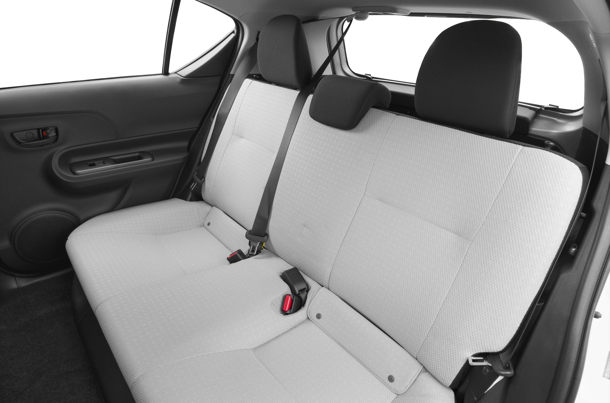 Rear bench seating with fabric upholstery and seatbelts inside a compact hatchback