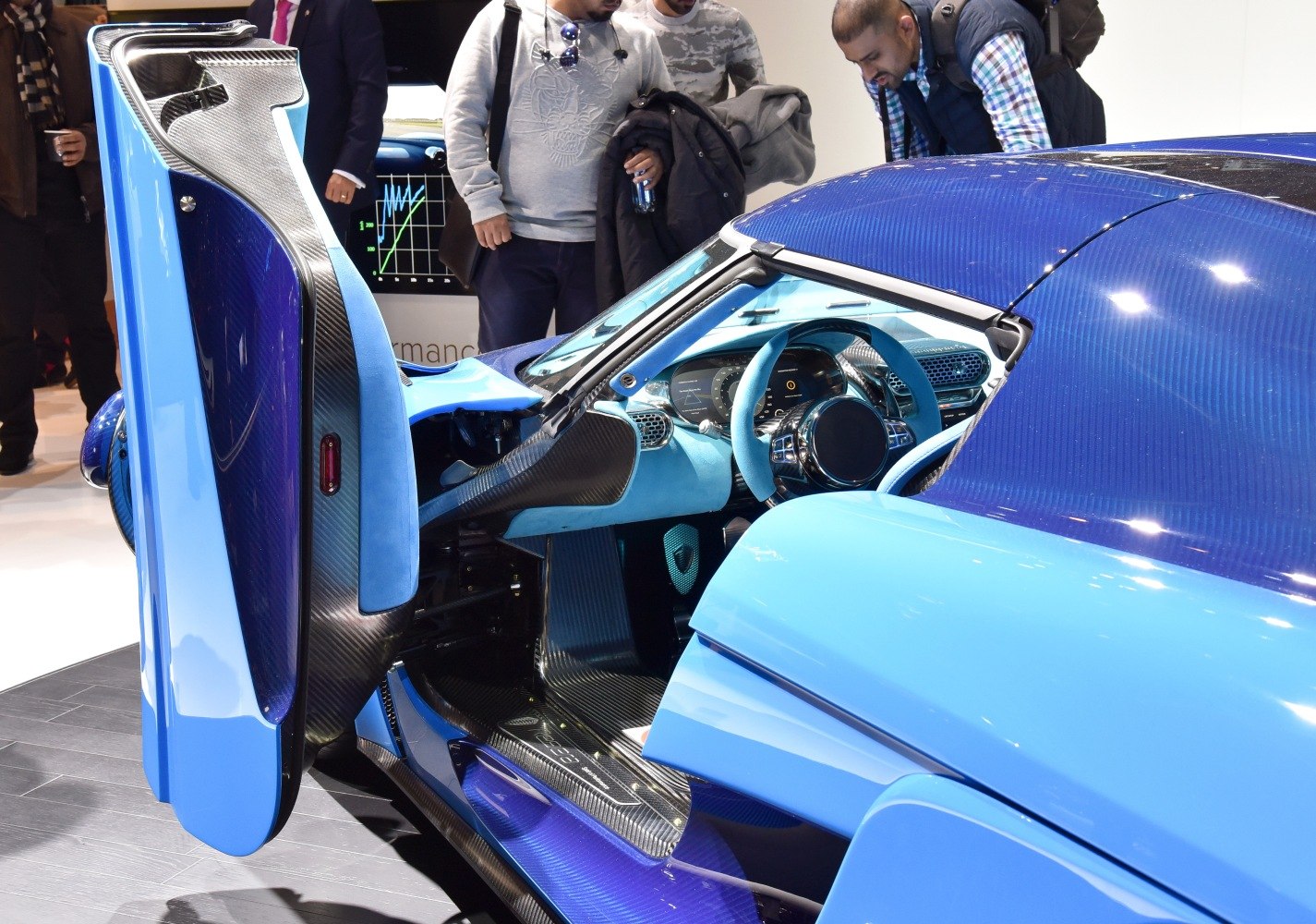 Open dihedral door and blue carbon fiber interior details