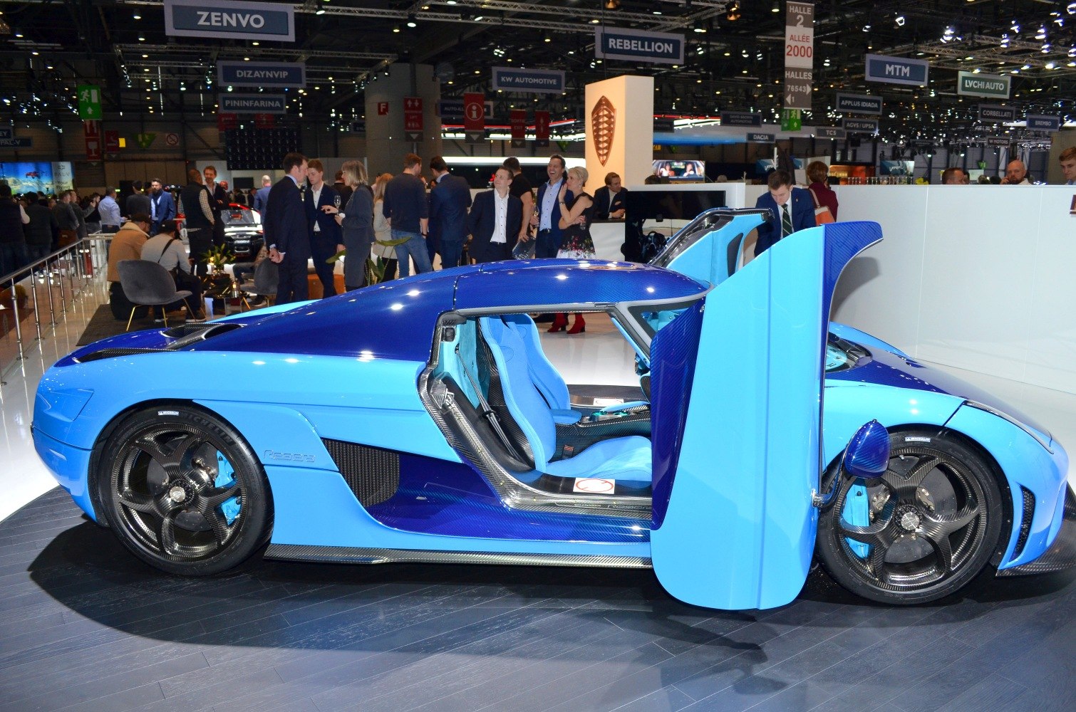 Blue hypercar with butterfly doors and carbon fiber wheels