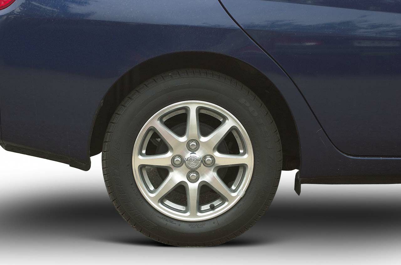 Close-up of alloy wheel and tire on blue car body