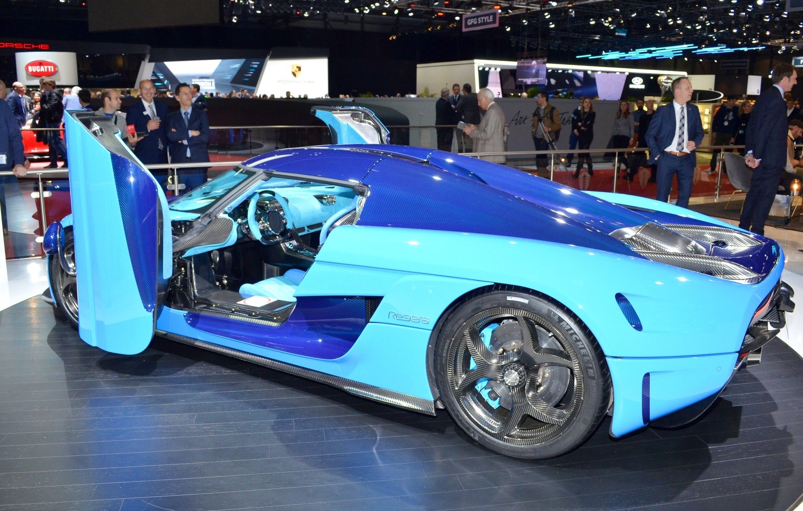 Blue sports car with butterfly doors and carbon fiber wheels