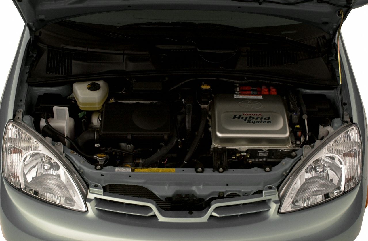 Engine bay showcasing hybrid system components and front headlights