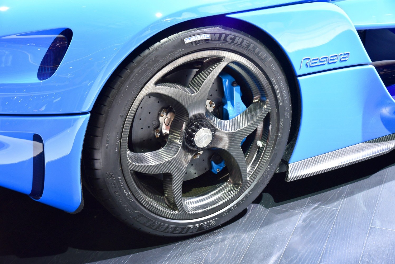 Carbon fiber wheel with drilled brake disc and blue caliper