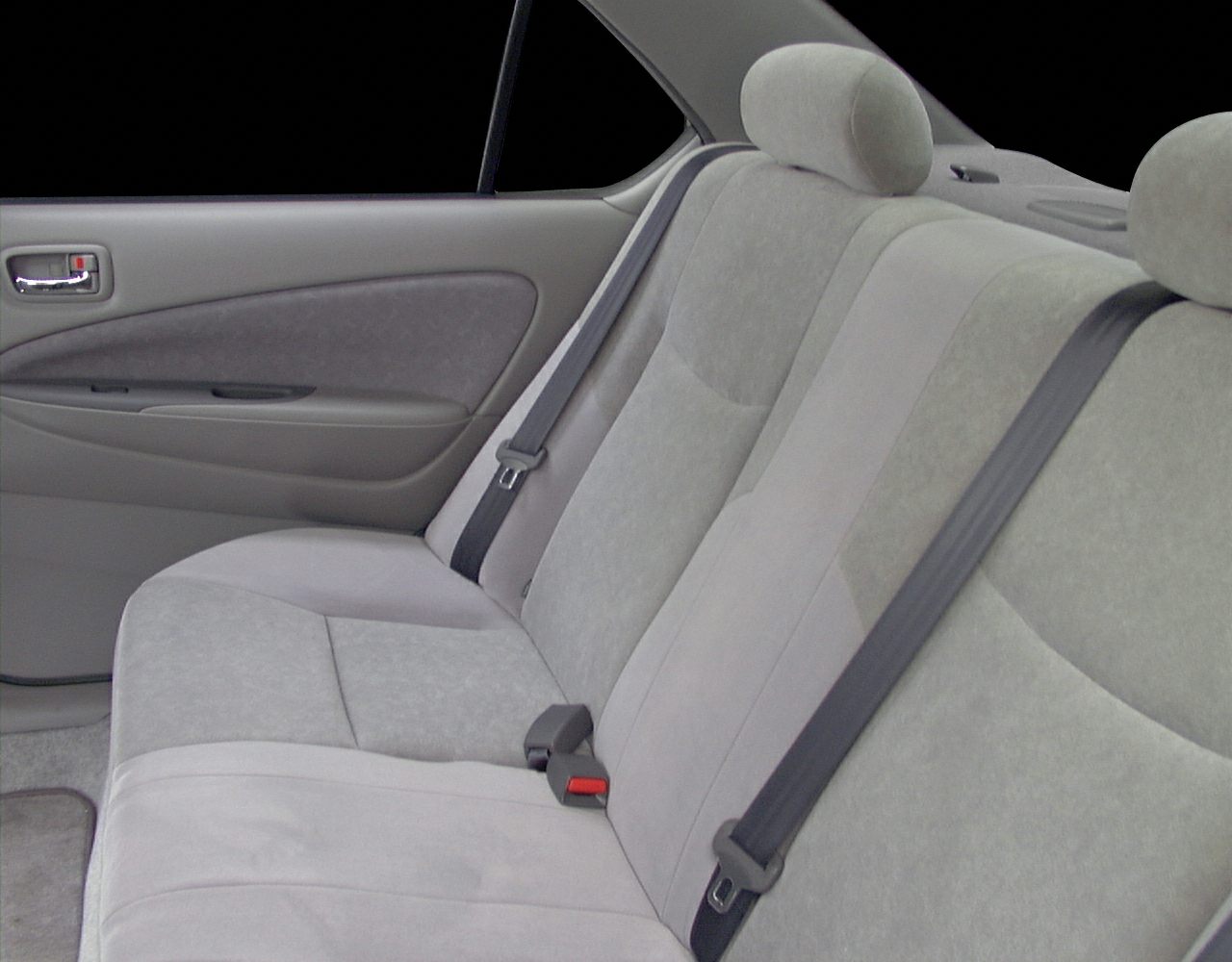 Rear seat with seat belts and headrests in a compact hybrid sedan.