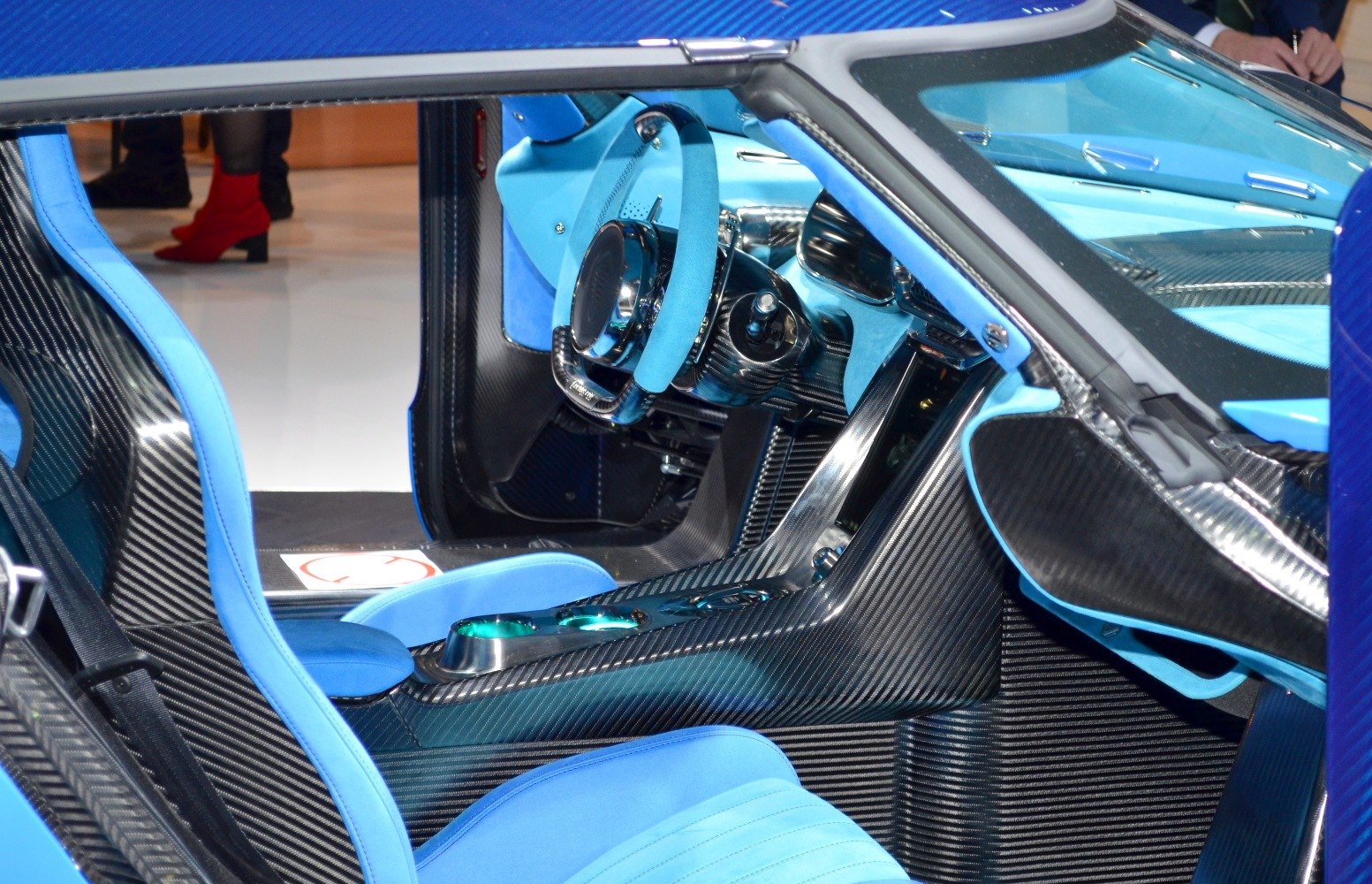 Carbon fiber interior with blue upholstery and futuristic steering wheel