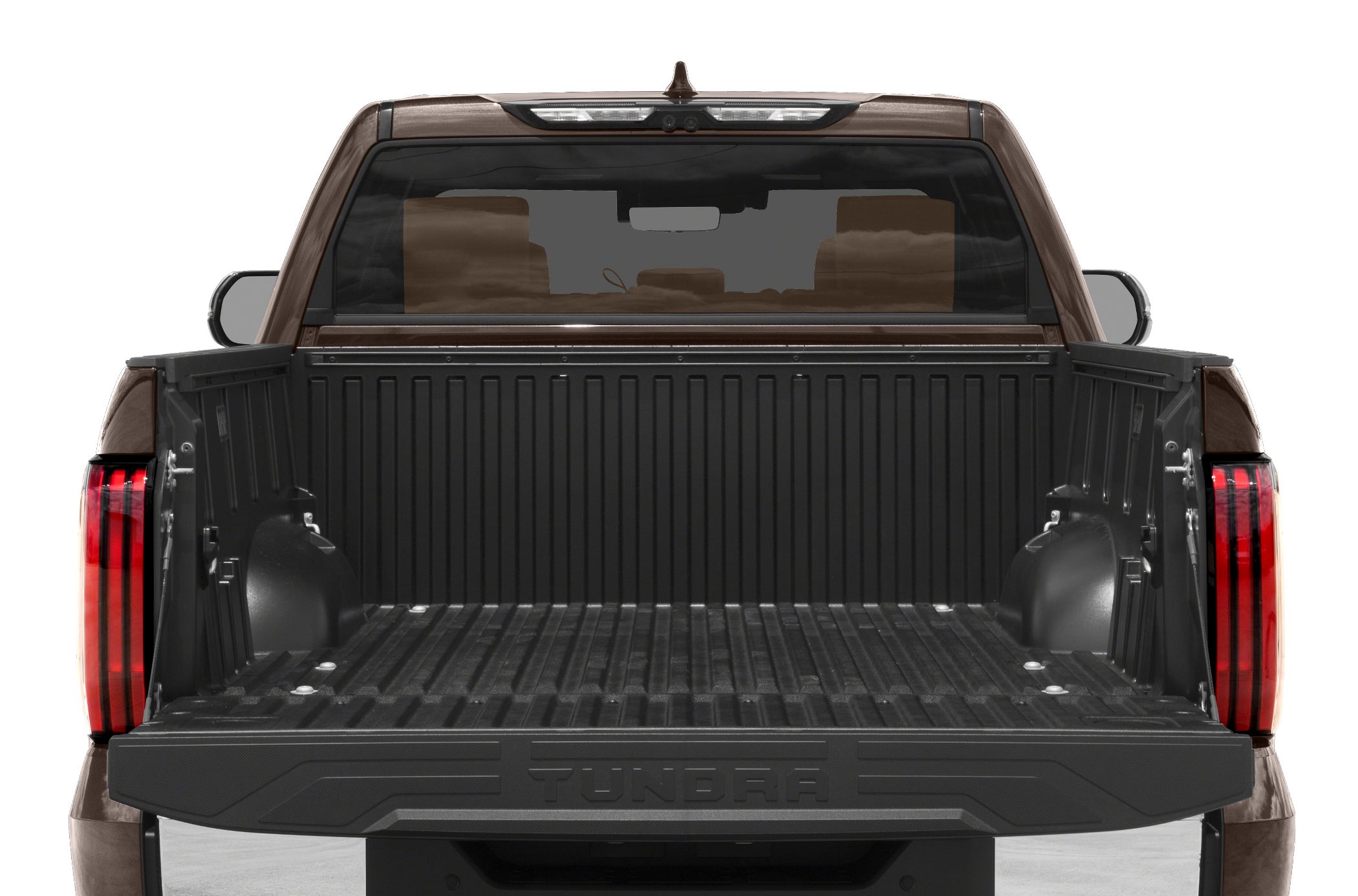 Open standard truck bed with protective liner and rear taillights.