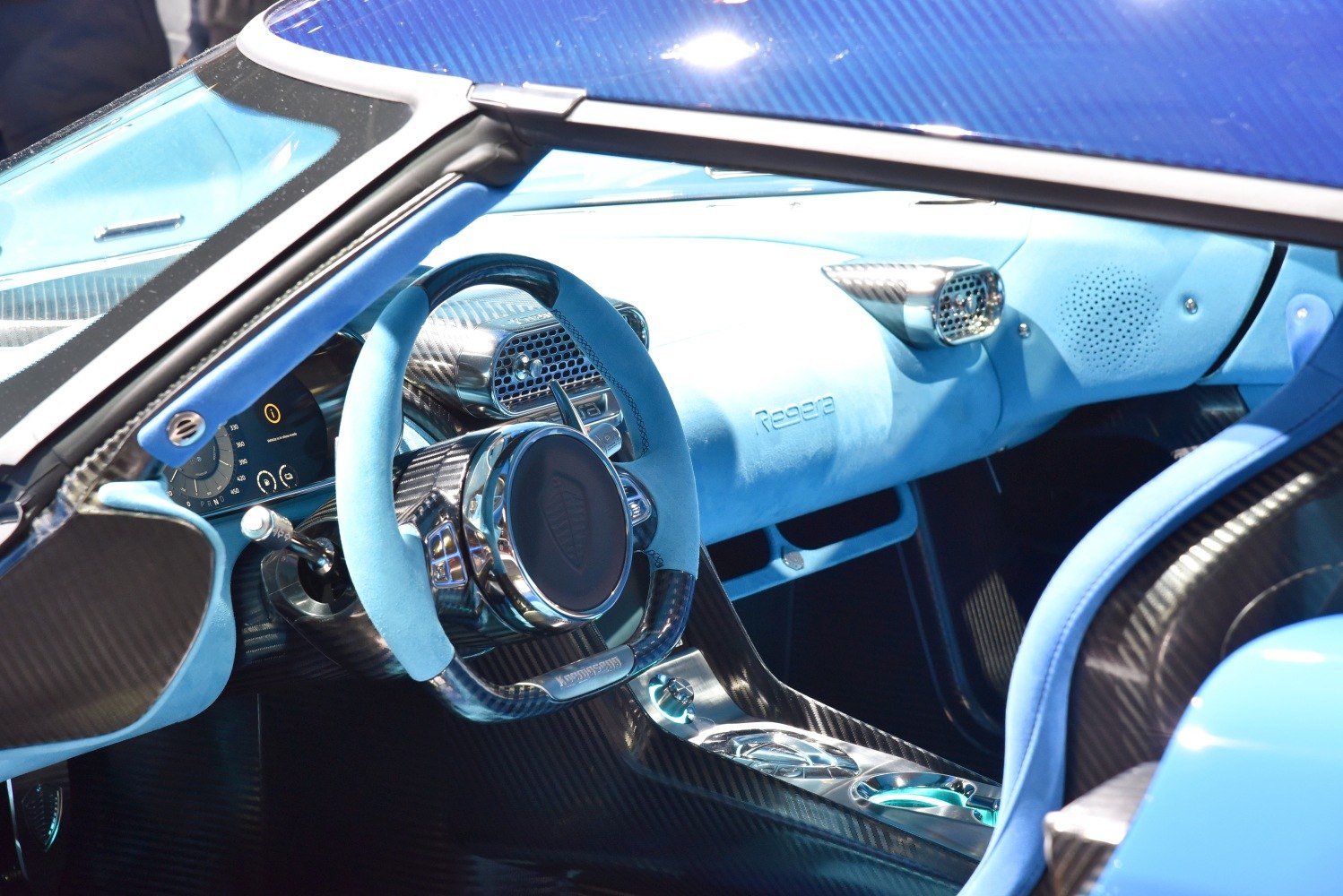 Blue Alcantara interior with carbon fiber trim and digital dashboard