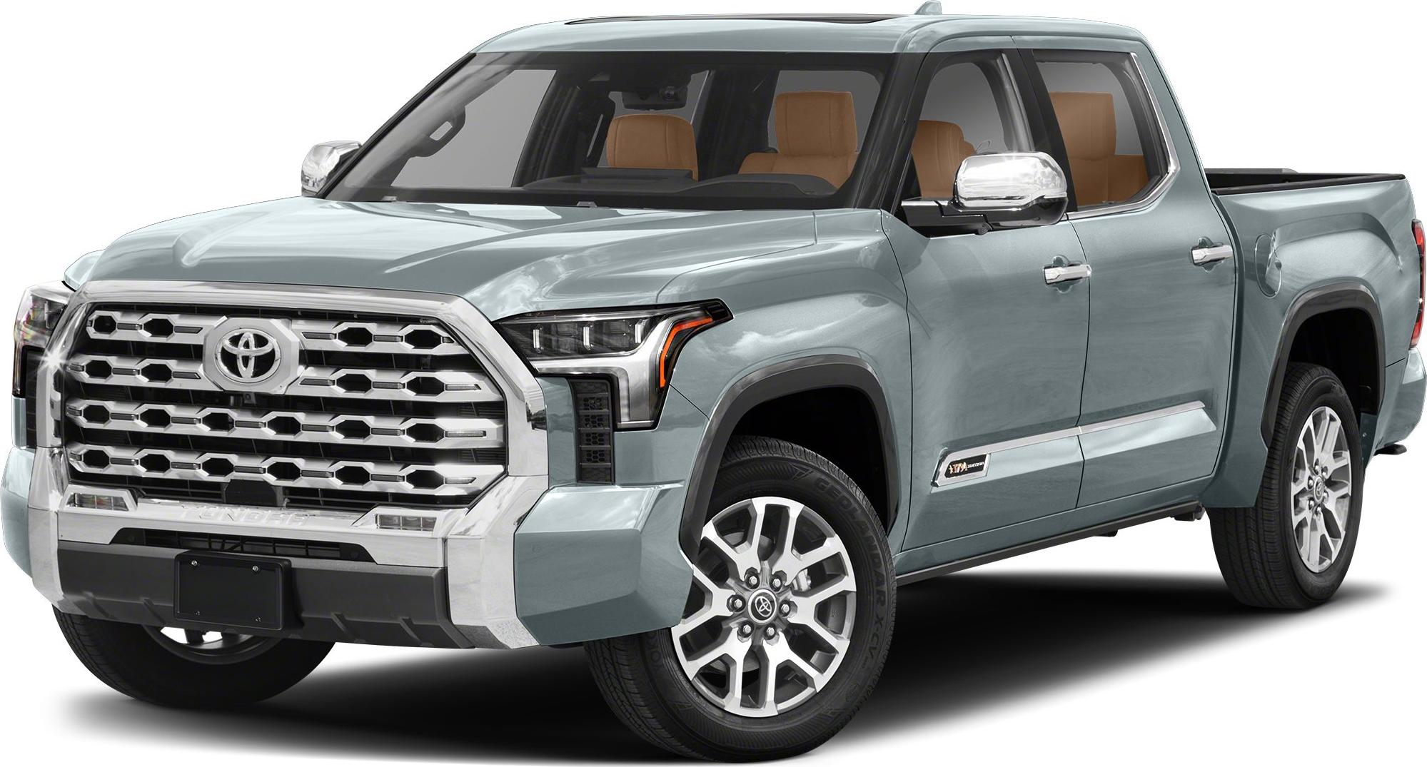 Front-side view of pickup truck with bold grille and crew cab short bed.