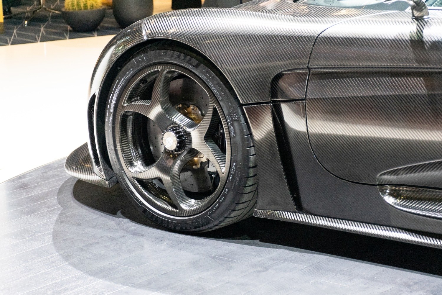 Carbon fiber wheel rim and body panel with visible brake disc
