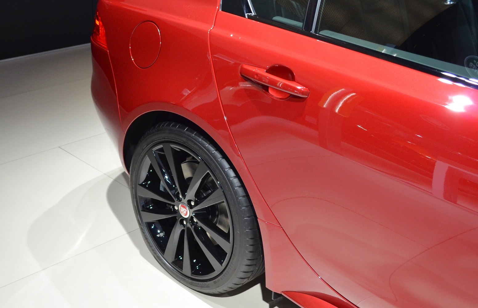 Red rear side with black alloy wheel and door handle
