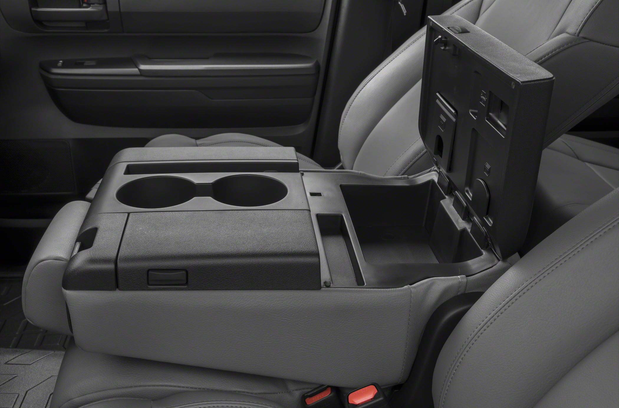 Center console with dual cup holders and open storage compartment