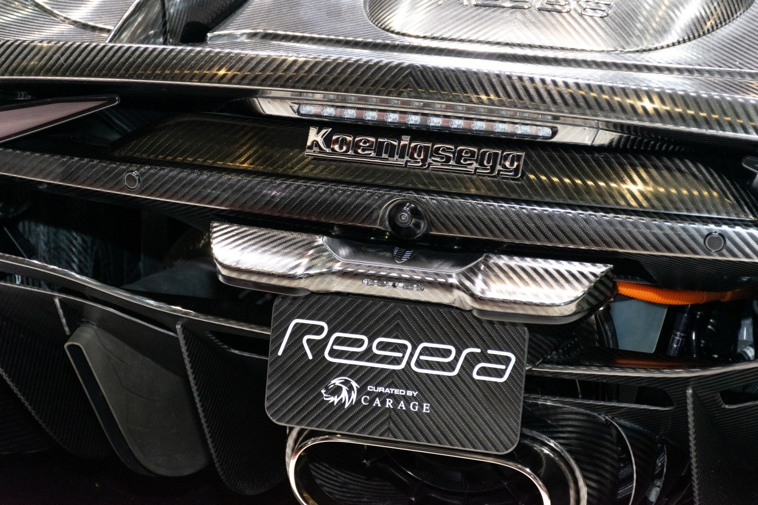 Rear section with carbon fiber finish, badge, and exhaust detailing