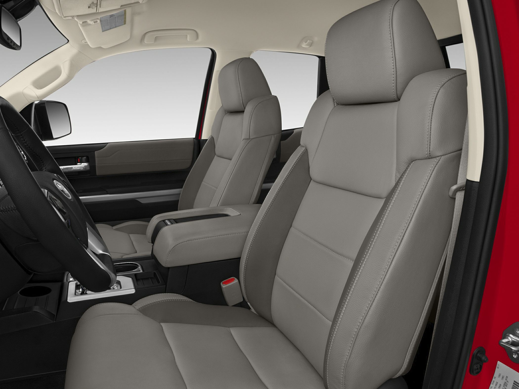 Front interior seats and central console with armrest in pickup truck