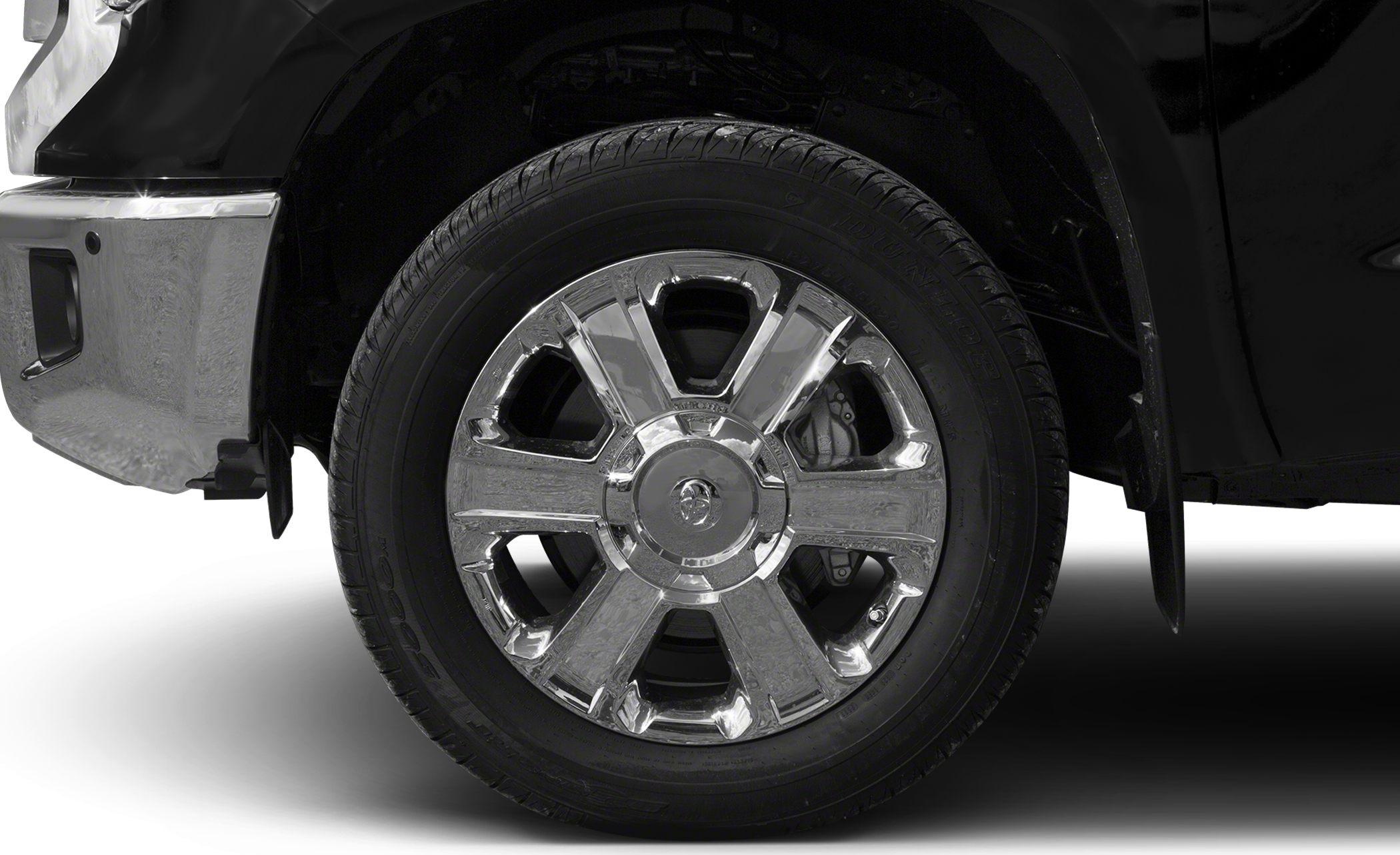 Close-up of chrome wheel rim and front bumper corner of a vehicle