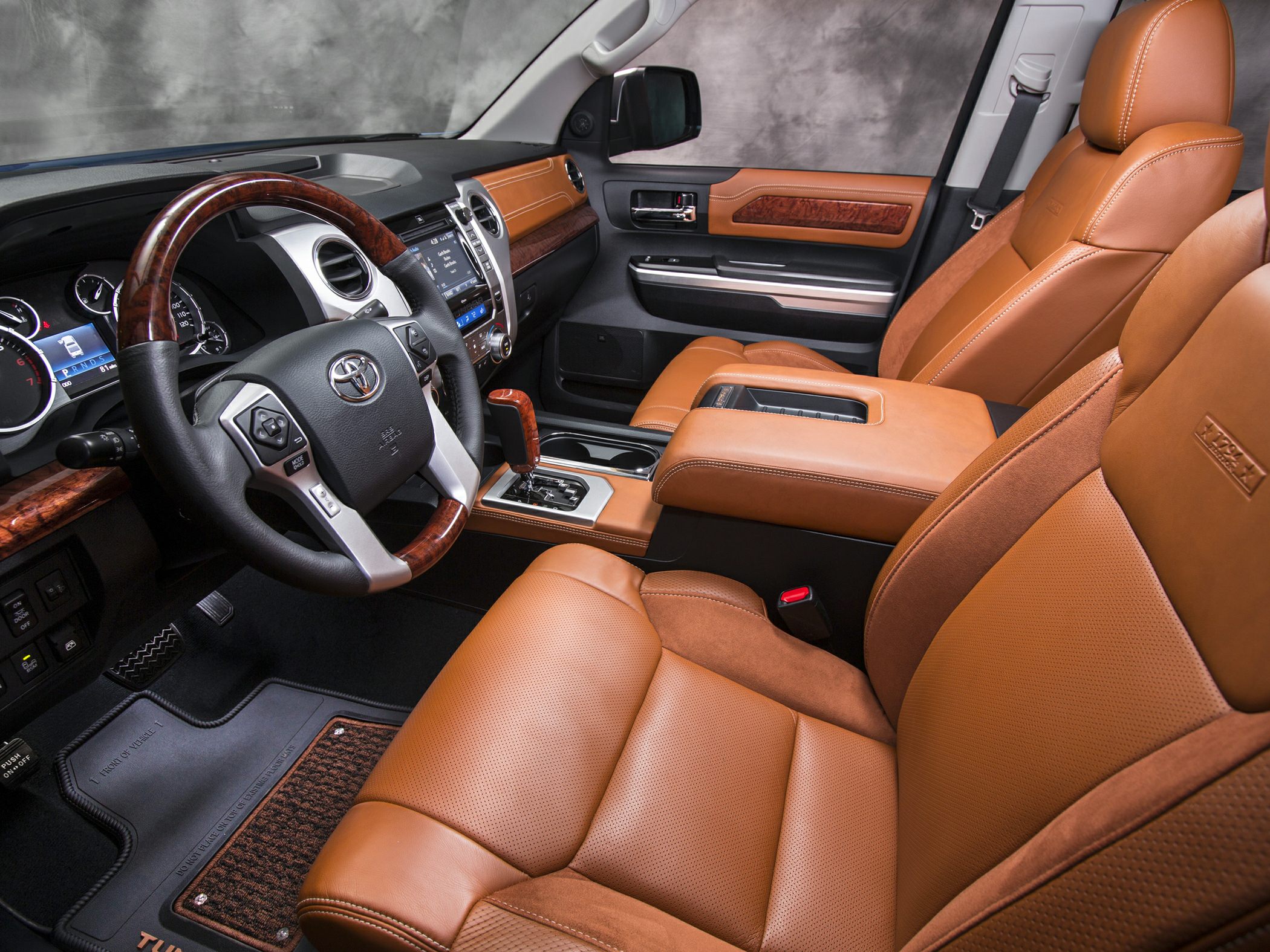 Brown leather seats and wood-accented dashboard interior.