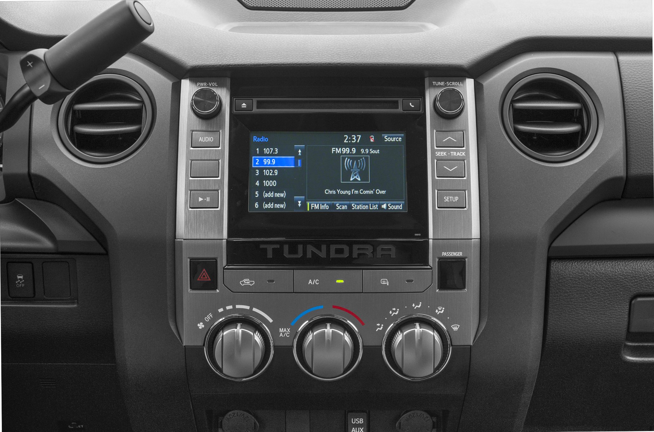 Infotainment system and manual climate control knobs on dashboard