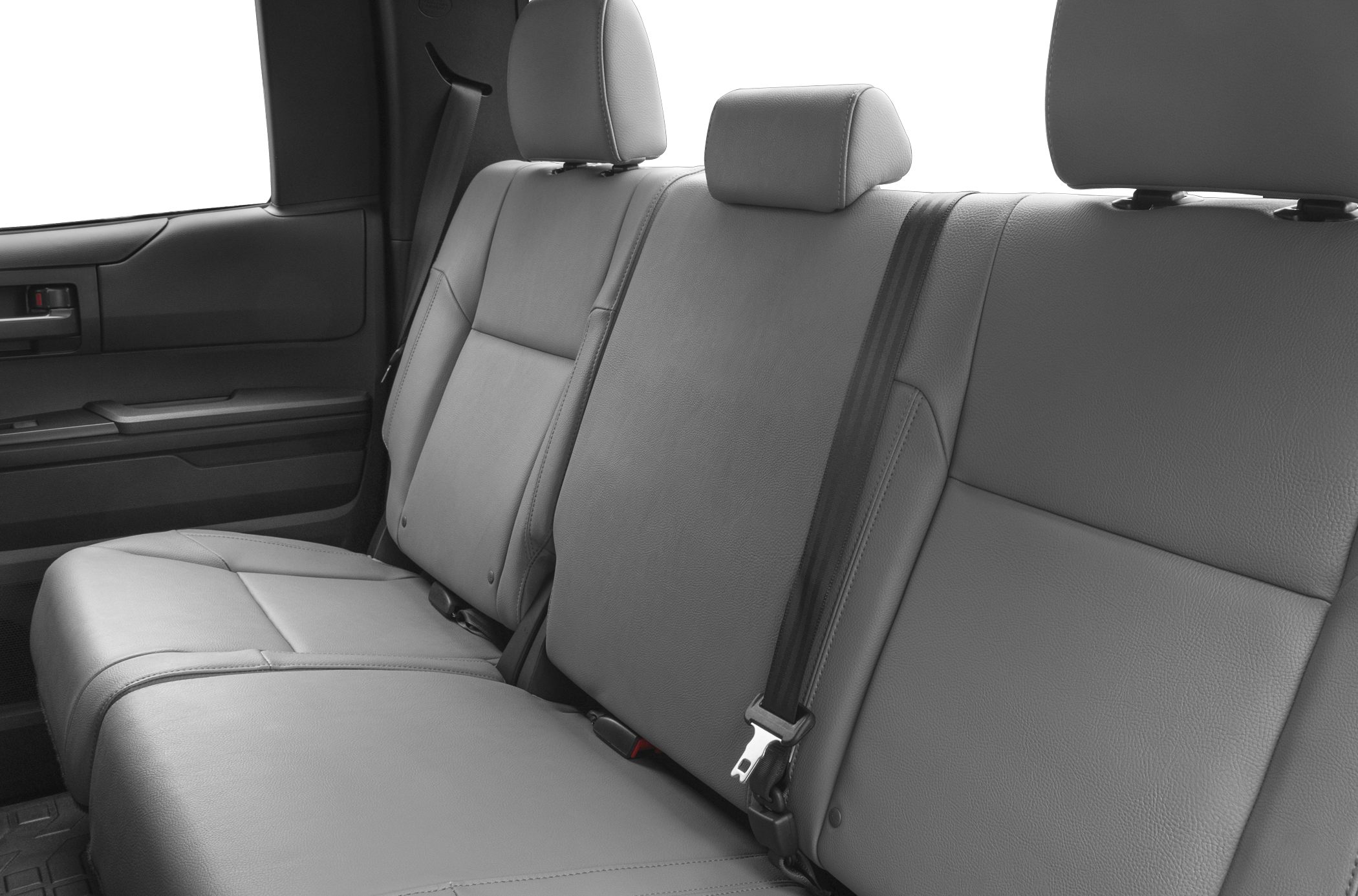 Rear leather seats with headrests and seatbelts in a spacious truck interior
