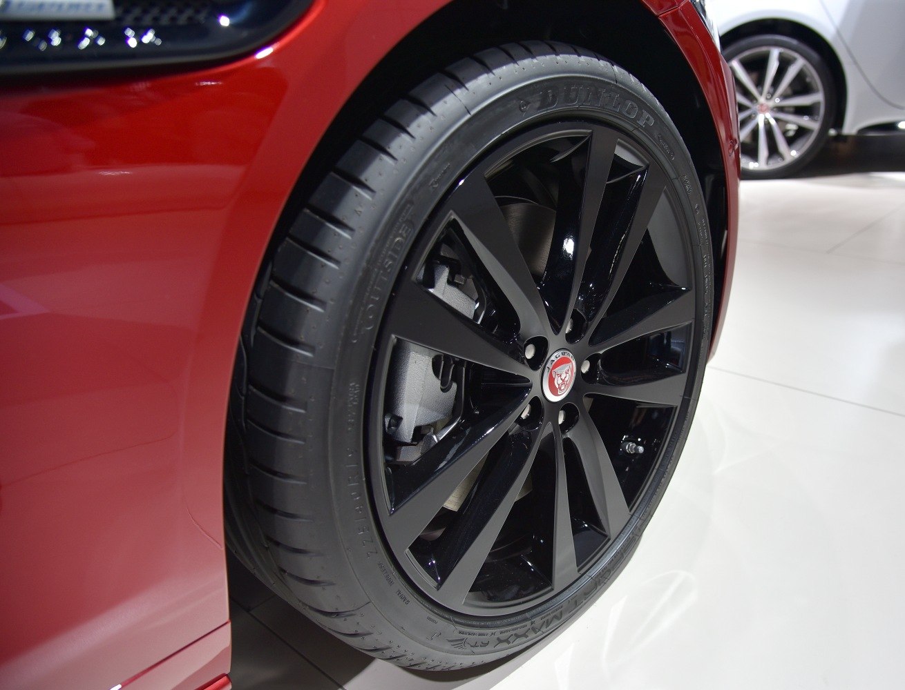 Black alloy wheel with tire close-up featuring Jaguar emblem