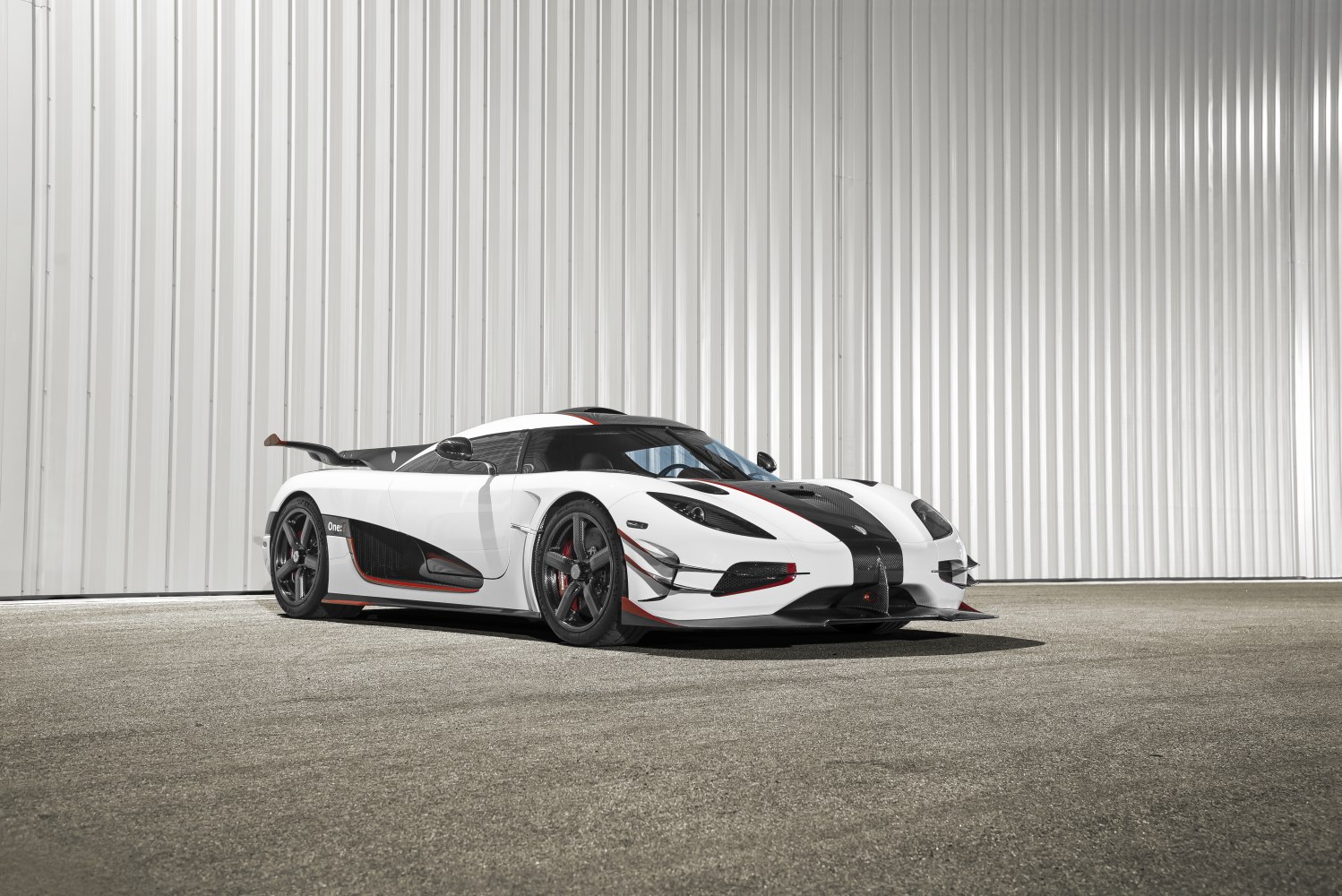 Low-slung hypercar front-side view with carbon fiber and aerodynamic styling