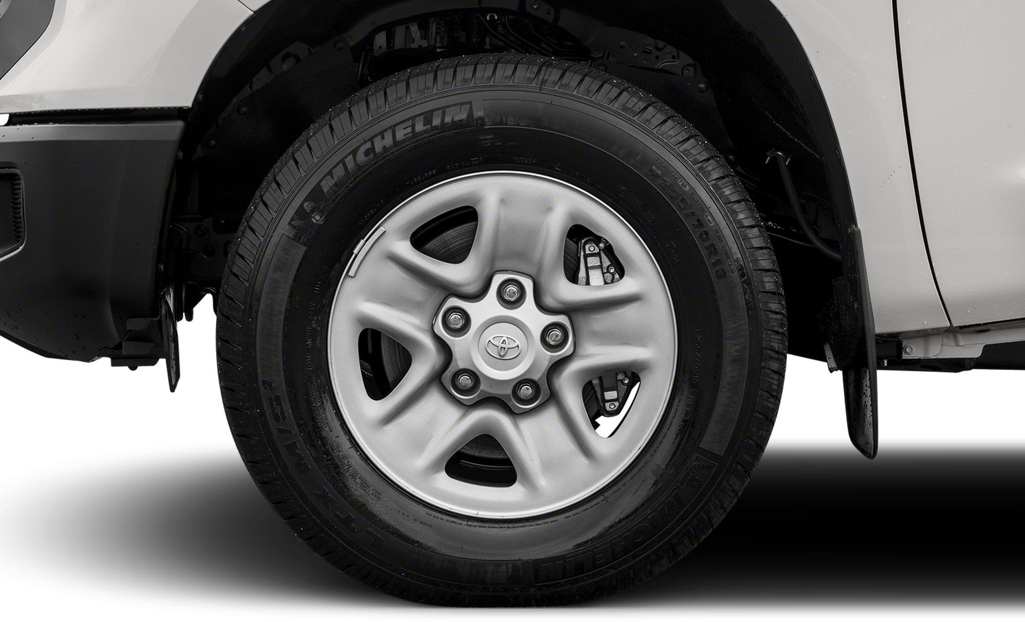 Close-up of alloy wheel and tire on a pickup truck.