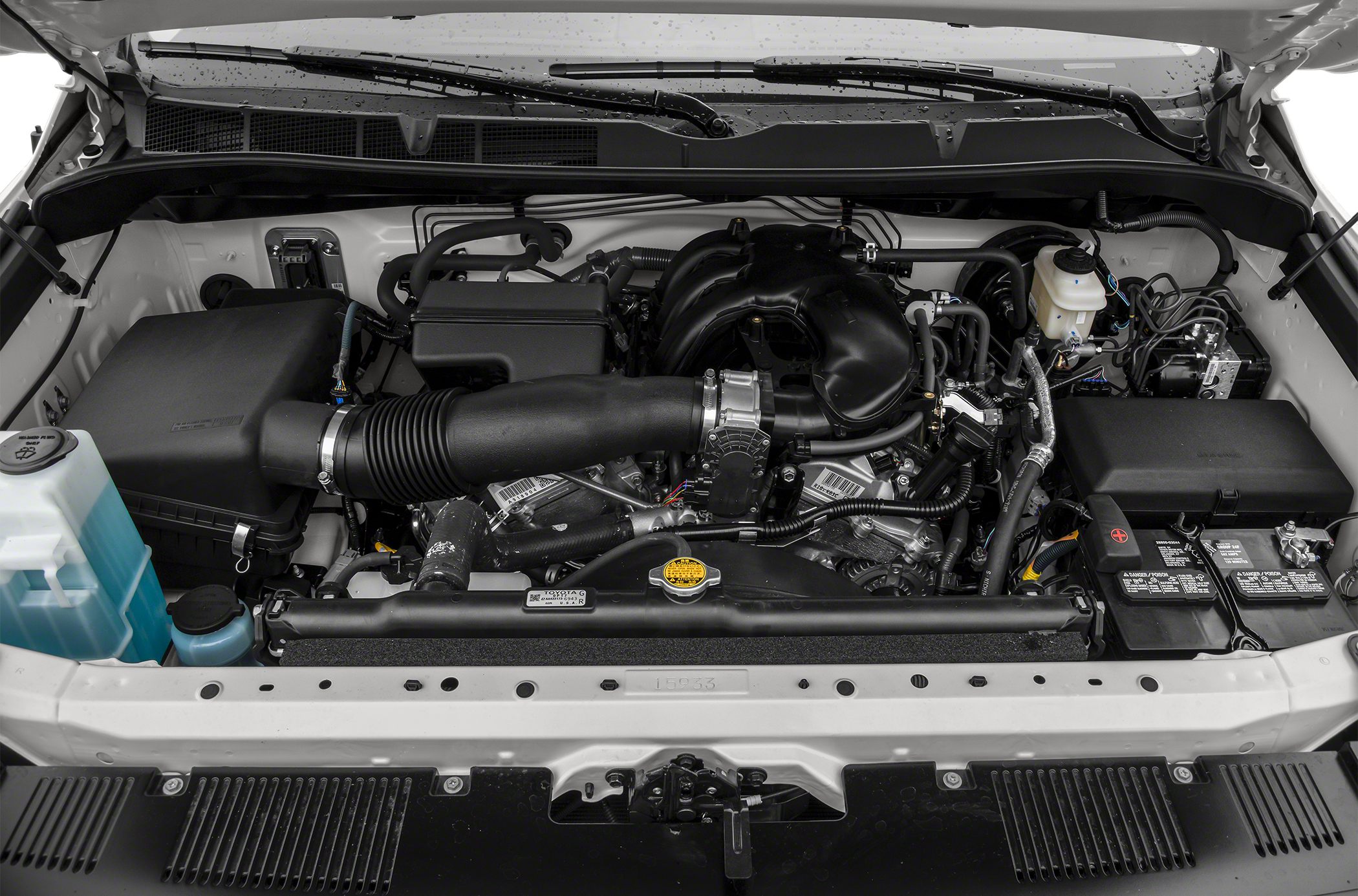 Engine bay with air intake system and fluid reservoirs