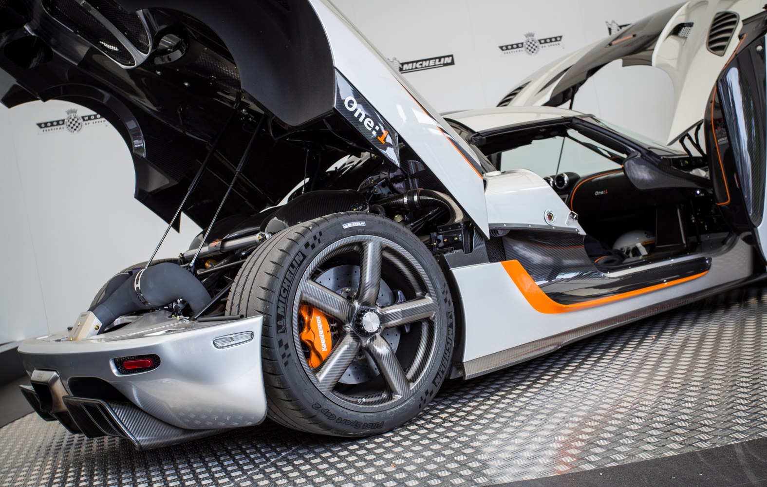 Carbon fiber rear wheel, orange brake calipers, open gullwing door