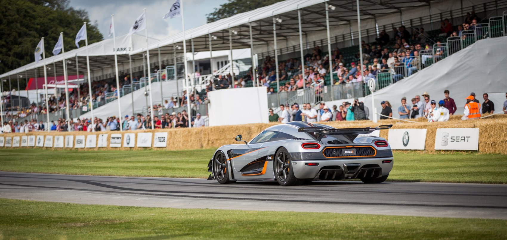 Rear view of sleek racing hypercar with aerodynamic spoiler and detailed bodywork.