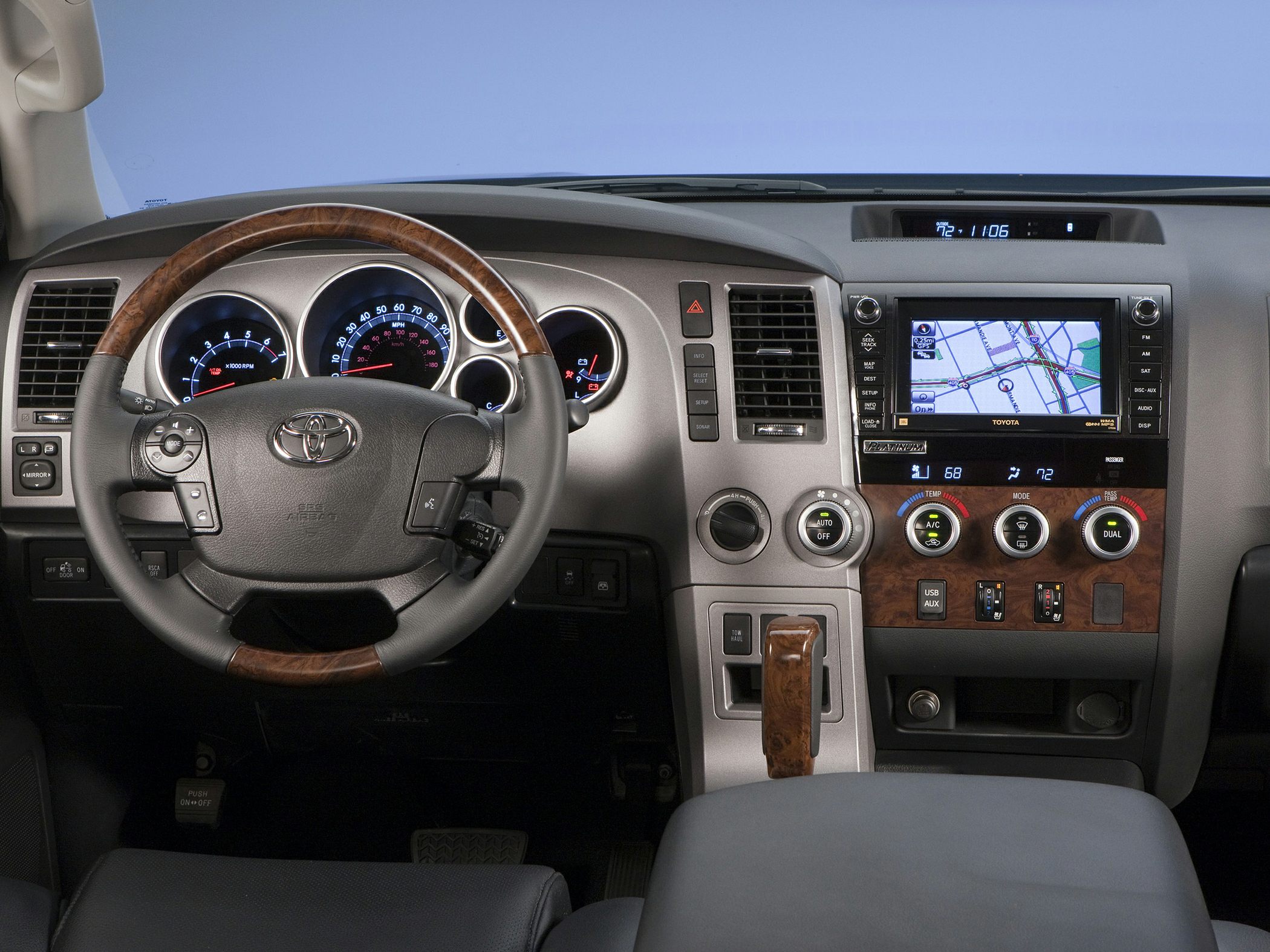 Dashboard and steering wheel with wood trim and navigation system